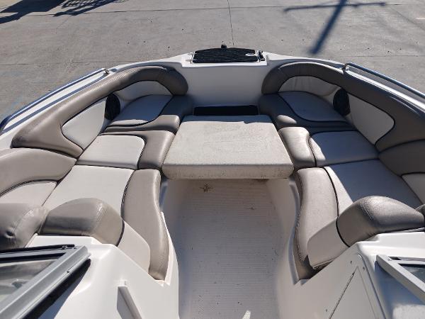 2010 Yamaha Boats 242 Limited interior with cushioned seating and table.