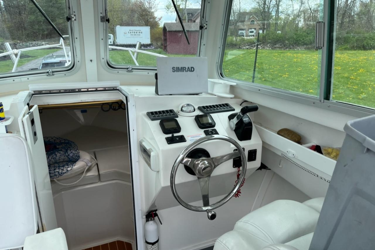 2012 Steiger Craft Miami boat interior with steering wheel and navigation equipment.