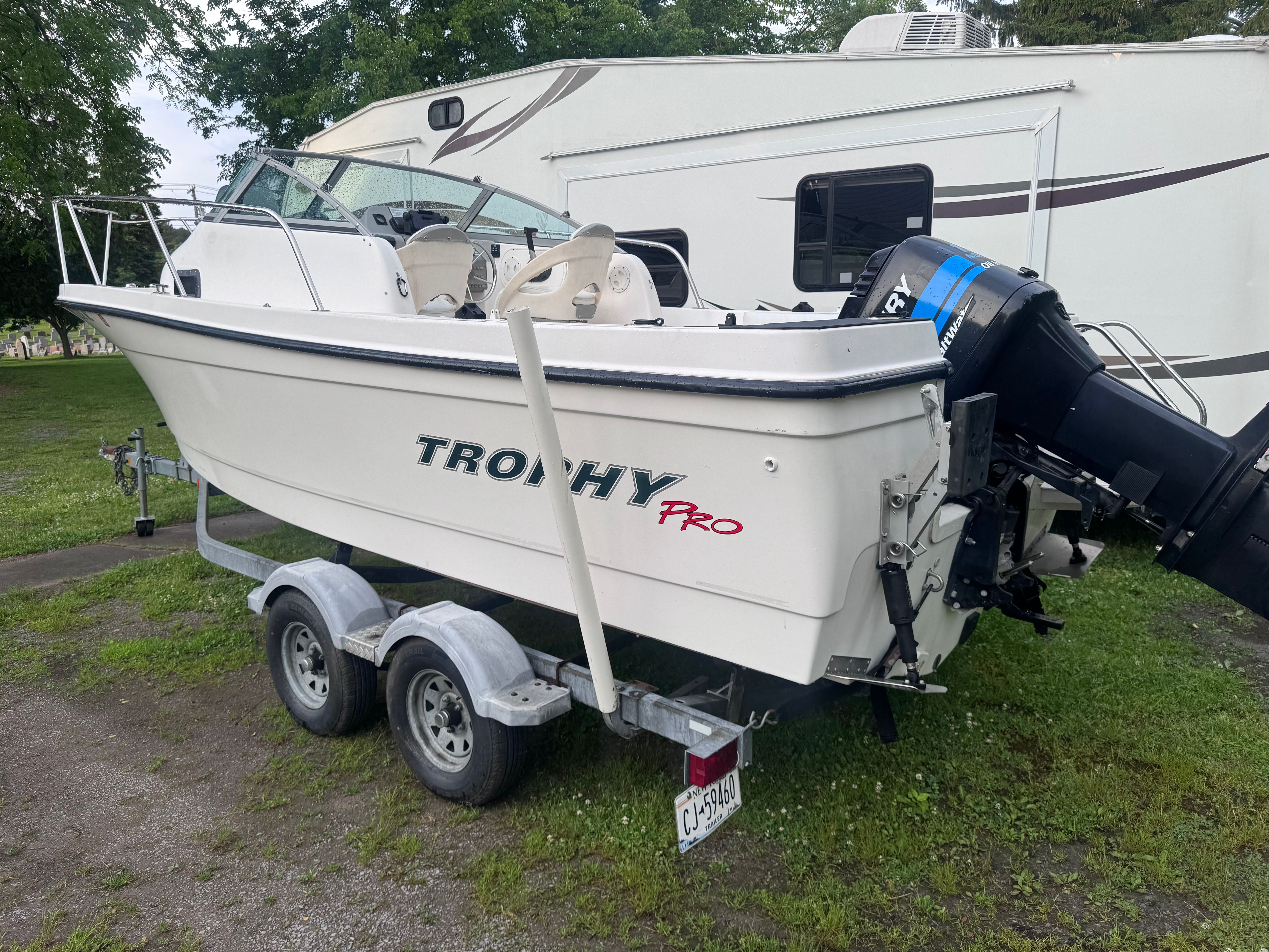 2005 Bayliner Trophy boat on trailer beside RV.