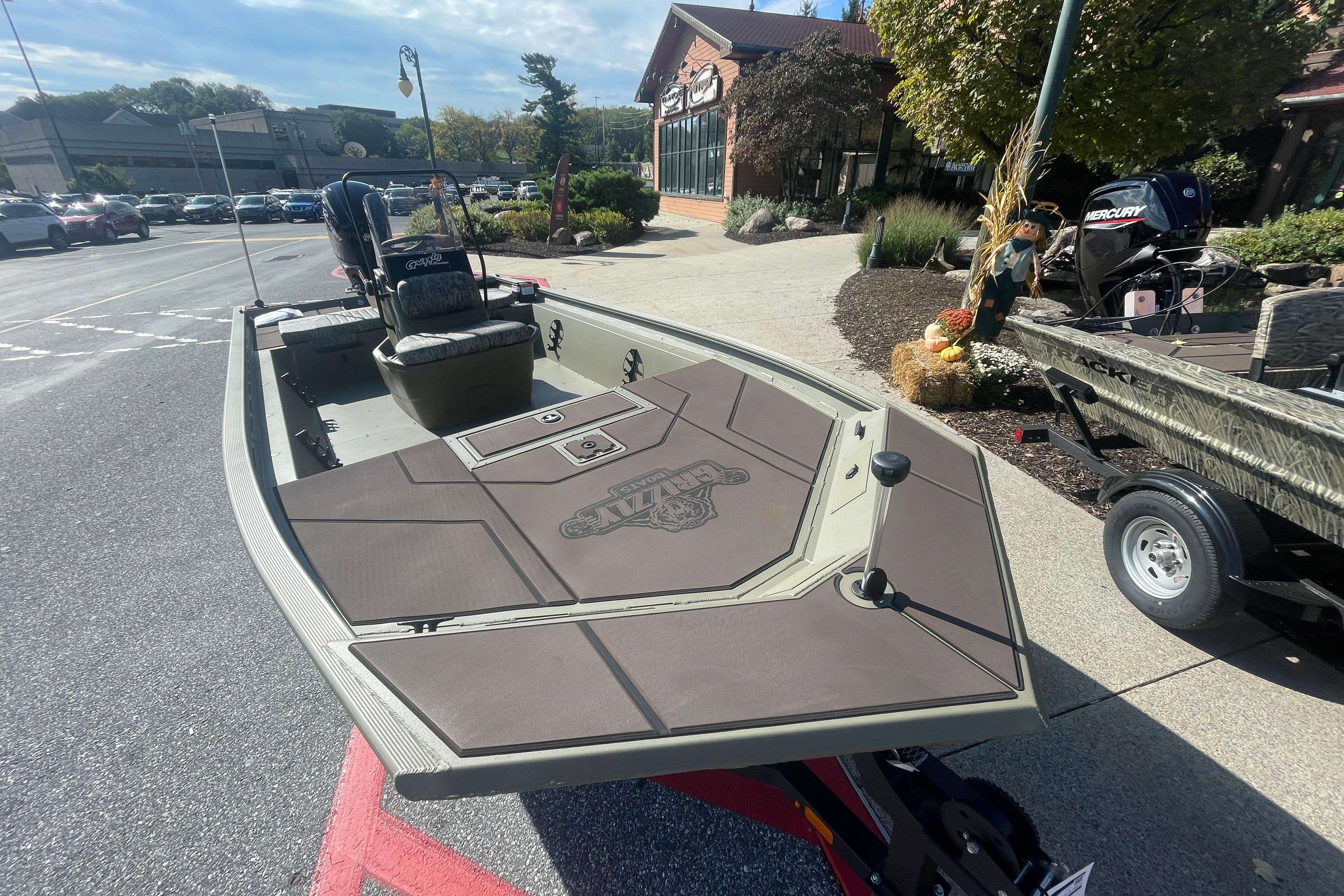2026 Tracker Grizzly 1860 CC boat displayed outdoors on a sunny day.