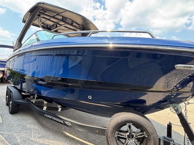 2026 Chaparral SSX 6 boat on trailer, sleek blue design under sunny sky.