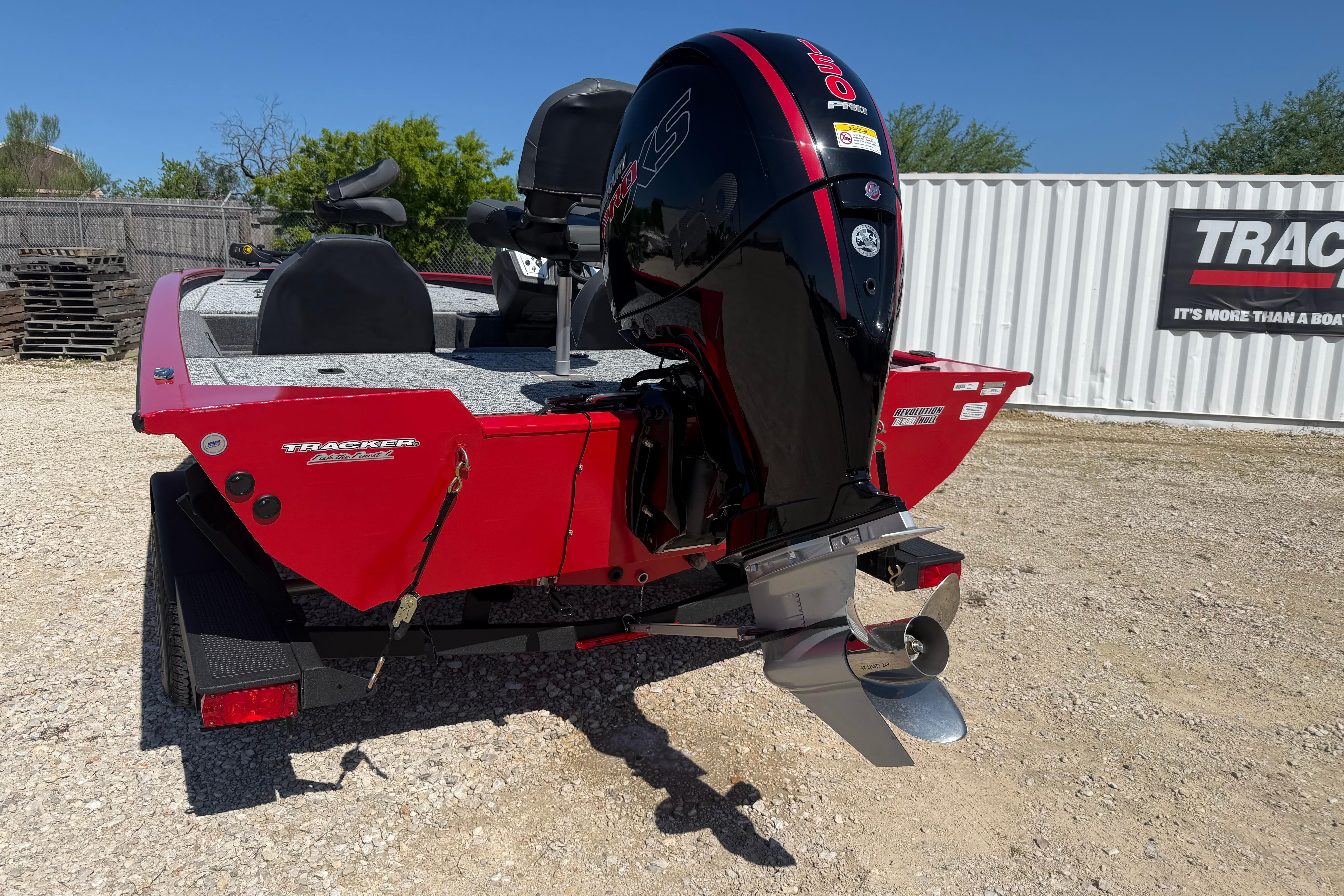 2026 Tracker Pro Team 195 boat with powerful outboard motor, parked outdoors.