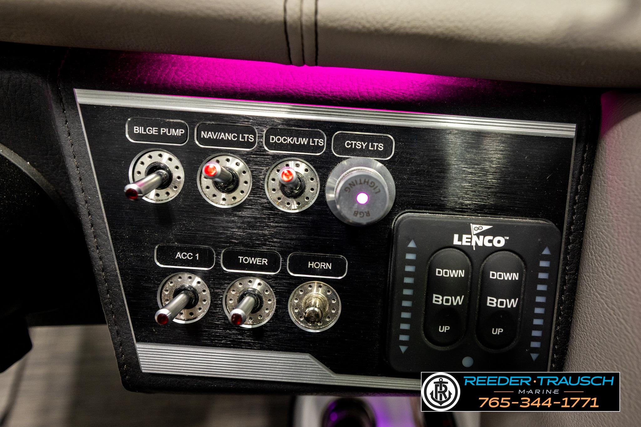 Control panel of 2024 FOURWINNS HD5 Surf boat with switches and Lenco trim tabs.