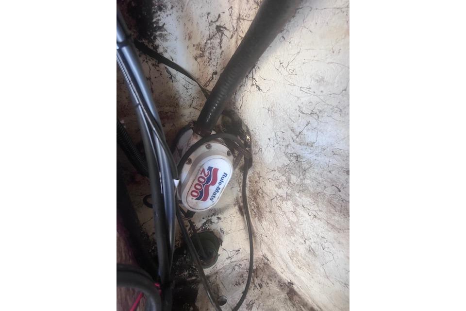 Bilge pump in a 2007 Sailfish 2660 CC boat, featuring wiring and hoses.