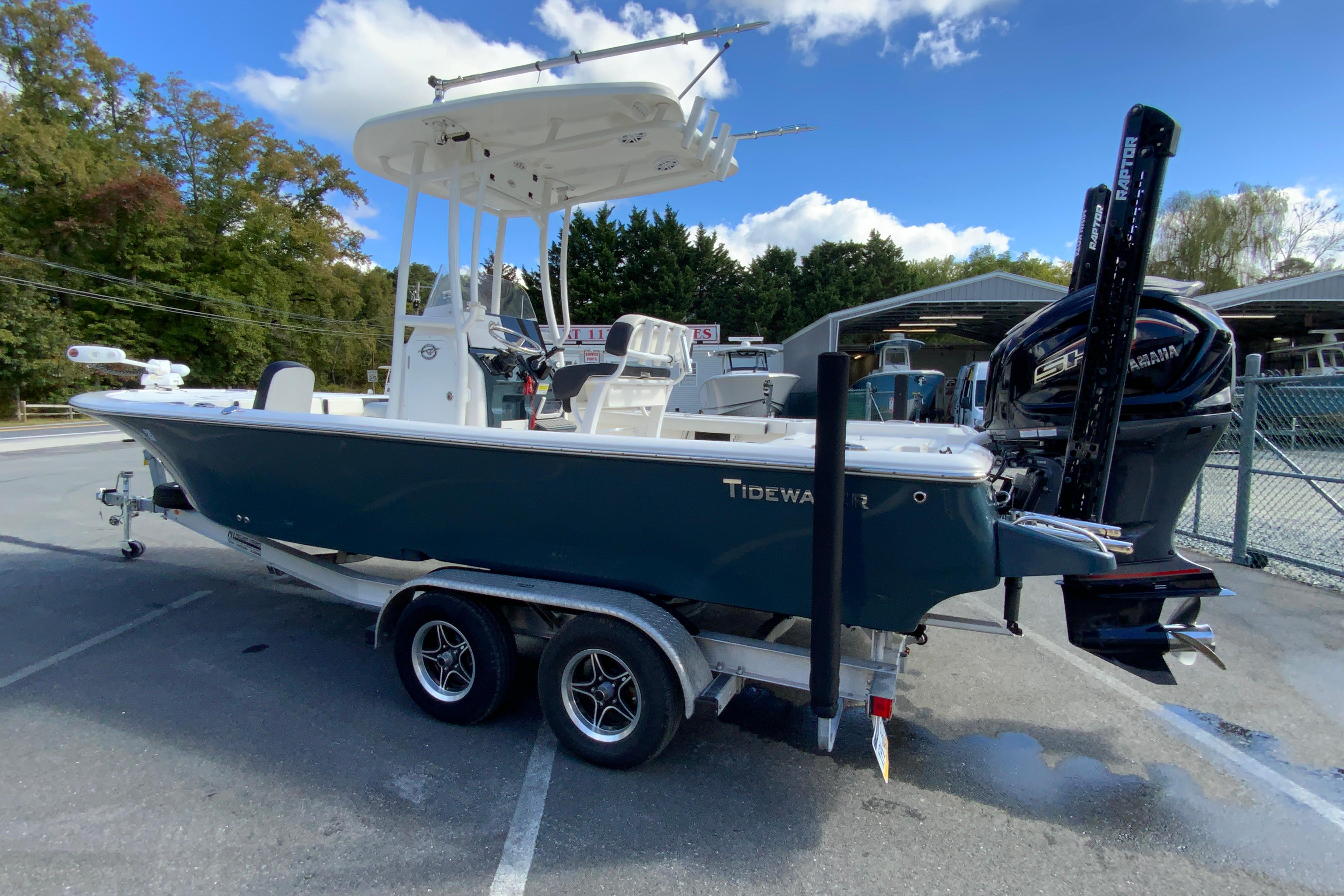 2022 Tidewater 2300 Carolina Bay boat on trailer, parked outdoors under blue sky.