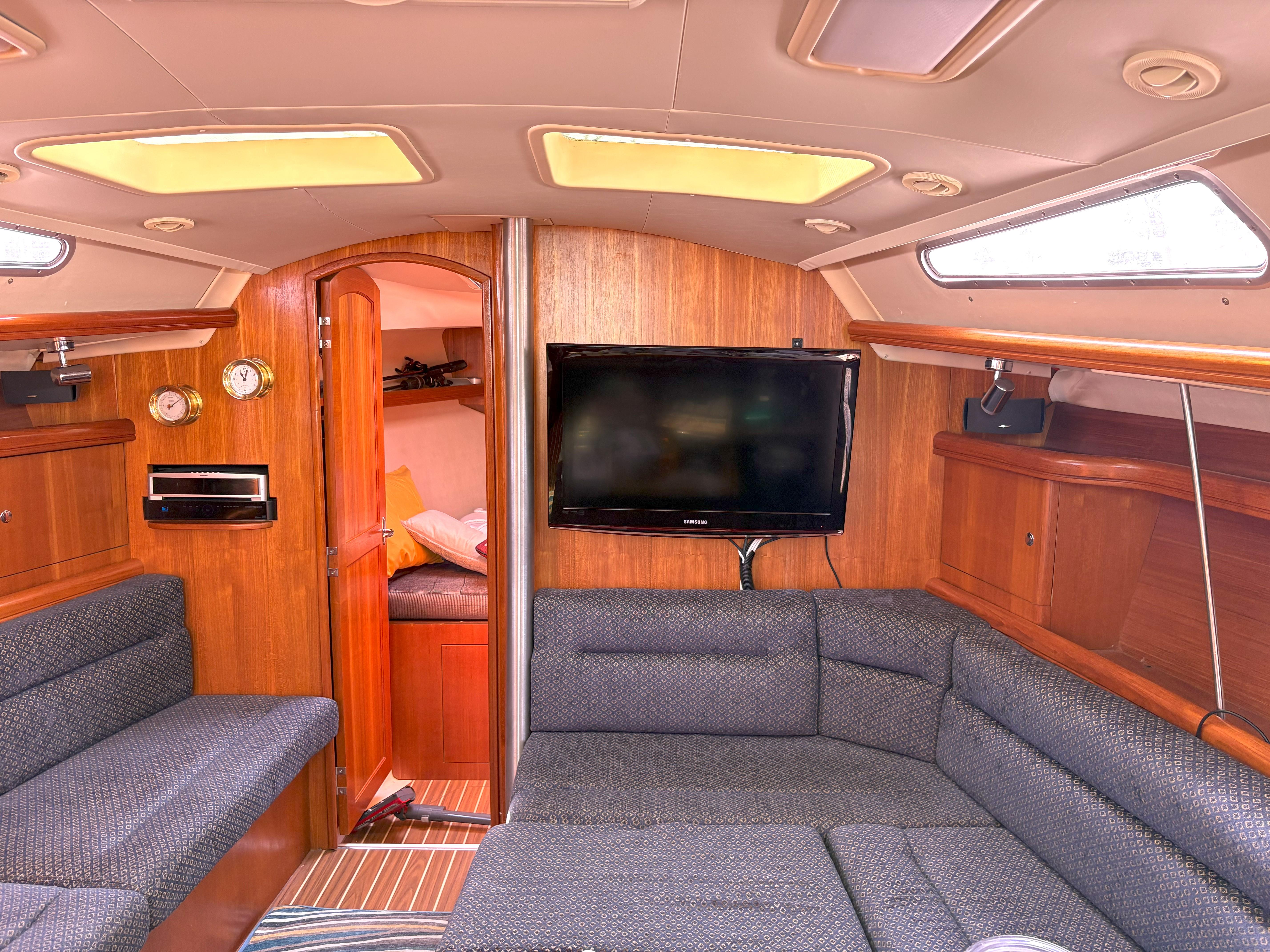 Luxurious interior of a 2005 Hunter 38 yacht with cozy seating and modern amenities.