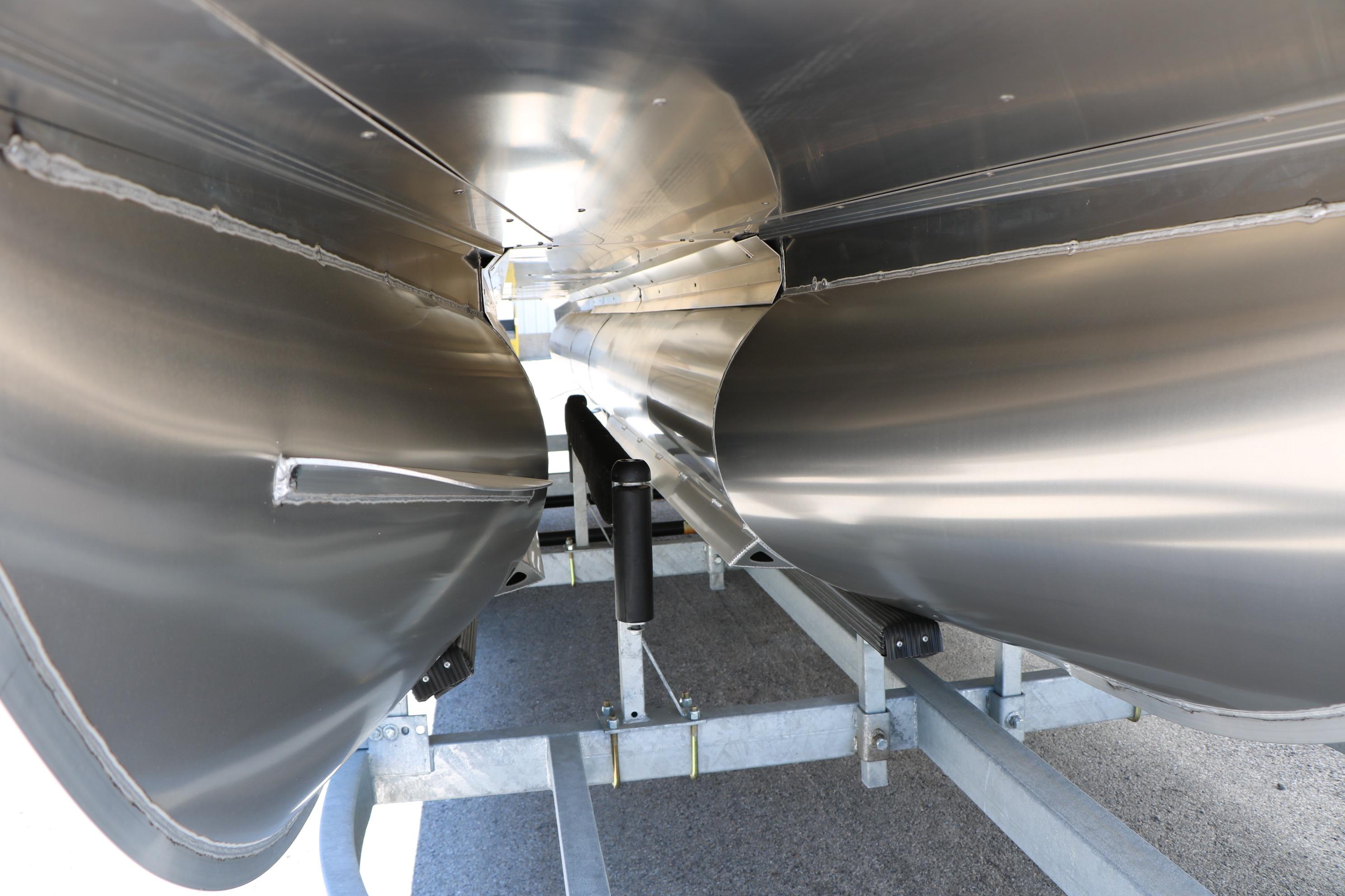 Underneath view of 2026 Evotti 521CS pontoon boat, showcasing sleek aluminum pontoons.