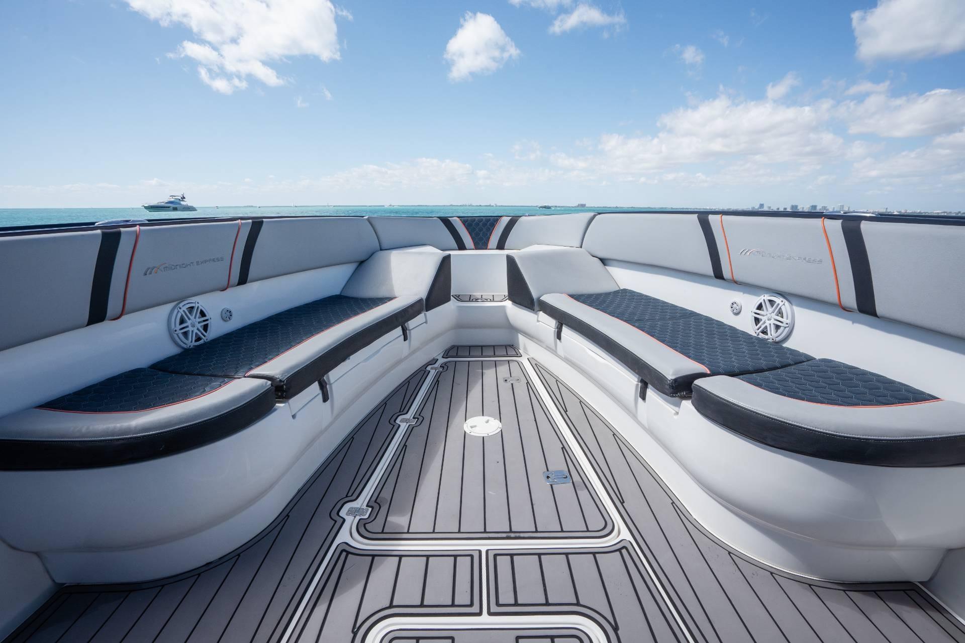 Luxurious seating on a 2014 Midnight Express 37 Open boat under a clear blue sky.