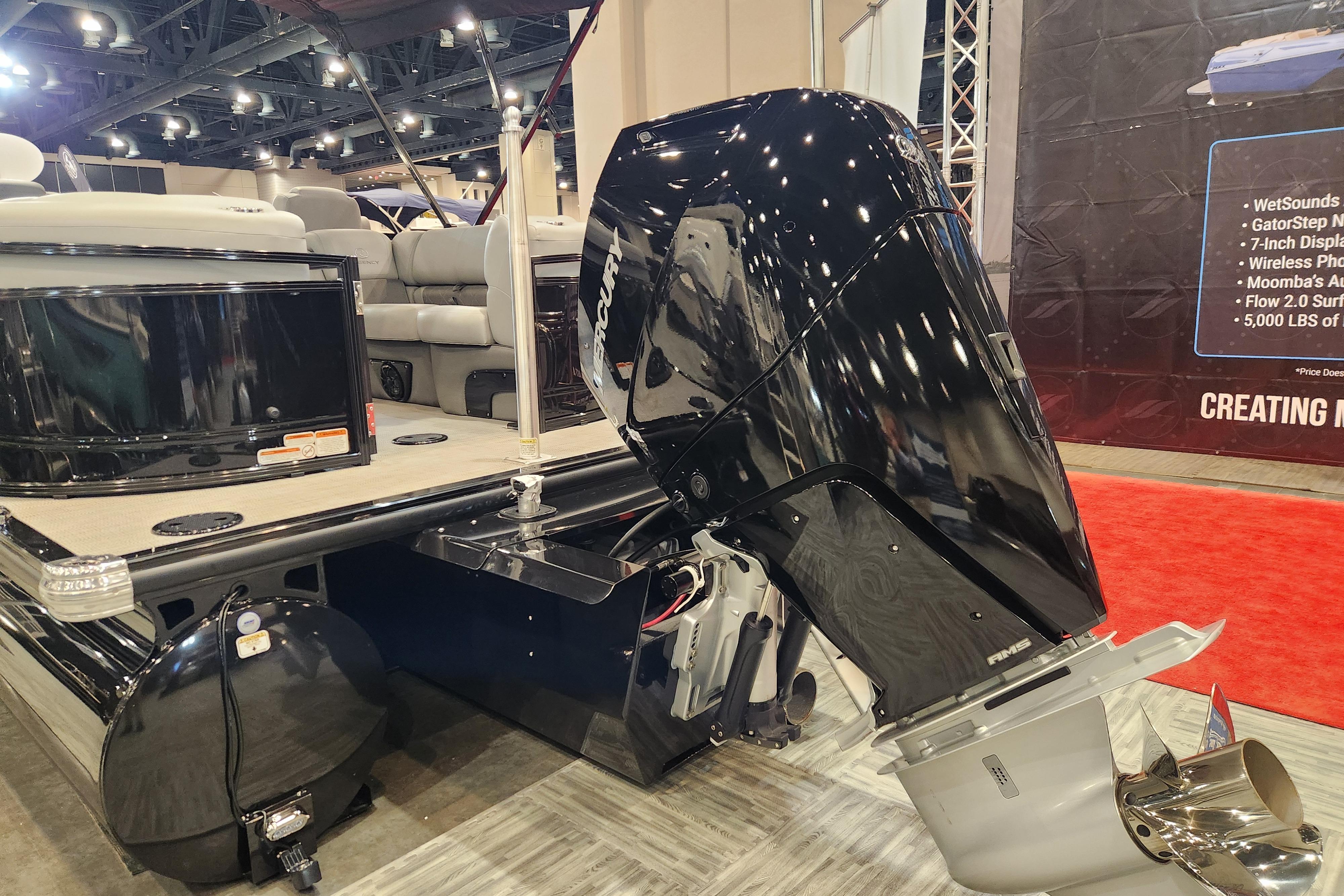 2025 Regency 250 LE3 boat with powerful Mercury outboard motor at a boat show.
