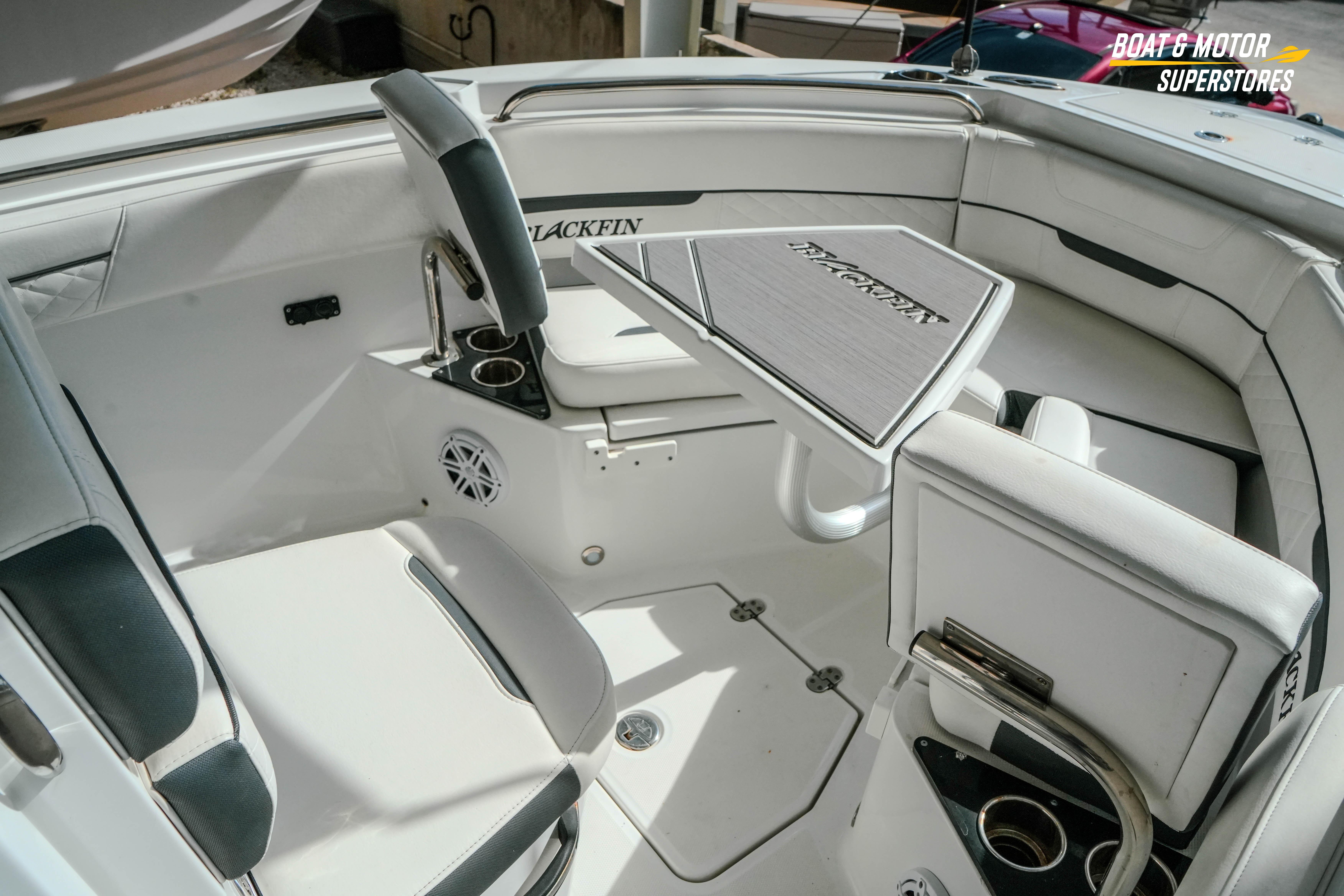 2022 Blackfin 222 CC boat interior with seating and table, showcasing luxury design.