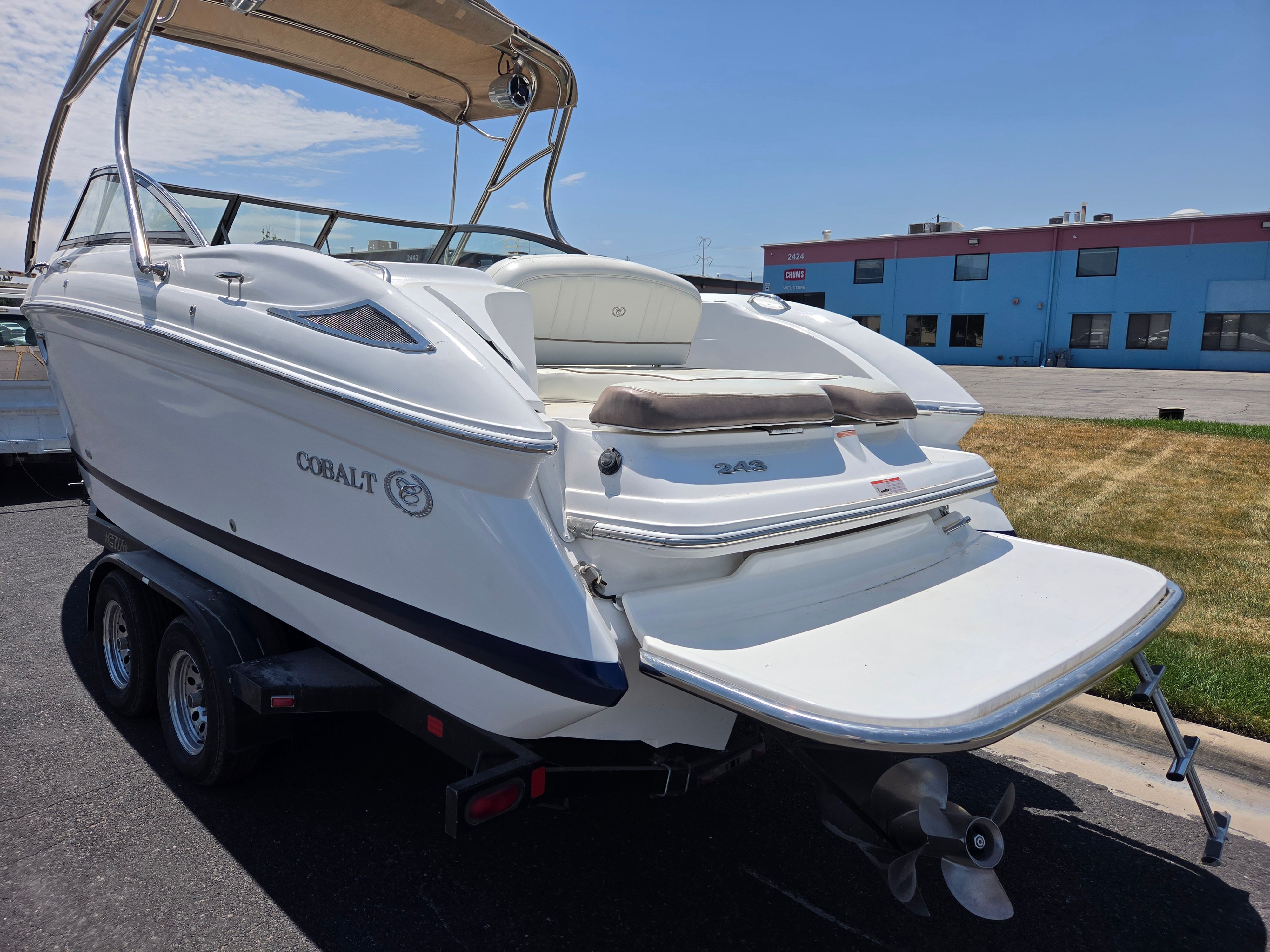 A Cobalt 243 boat on a trailer, ready for transport.