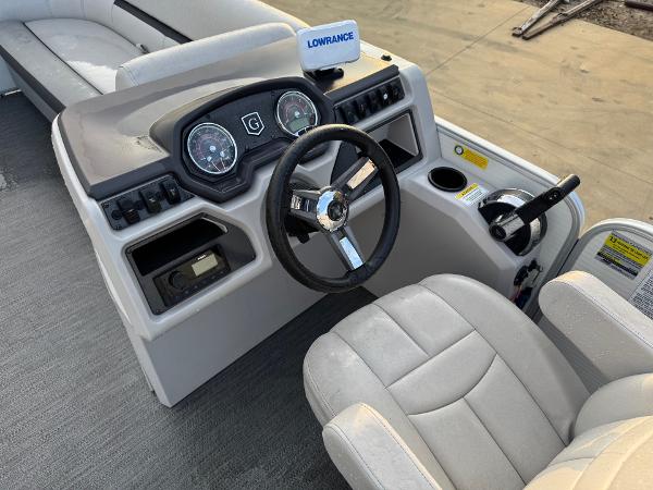 2022 Godfrey 2286 boat dashboard with steering wheel and control panel.