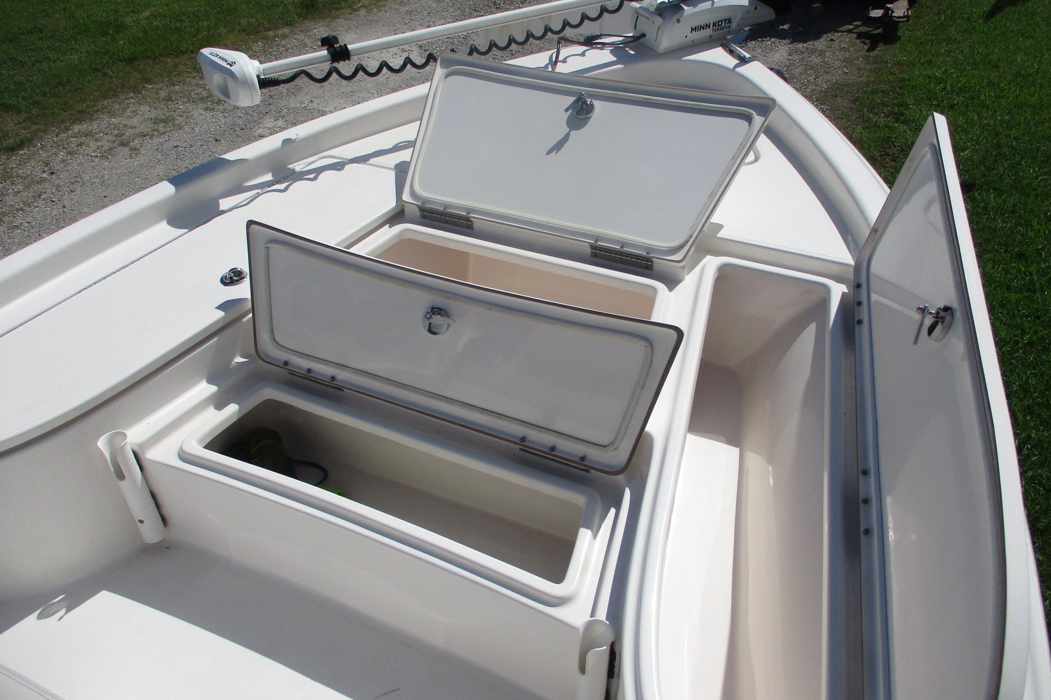 2021 Blue Wave 2000 PureBay boat with open storage compartments on deck.