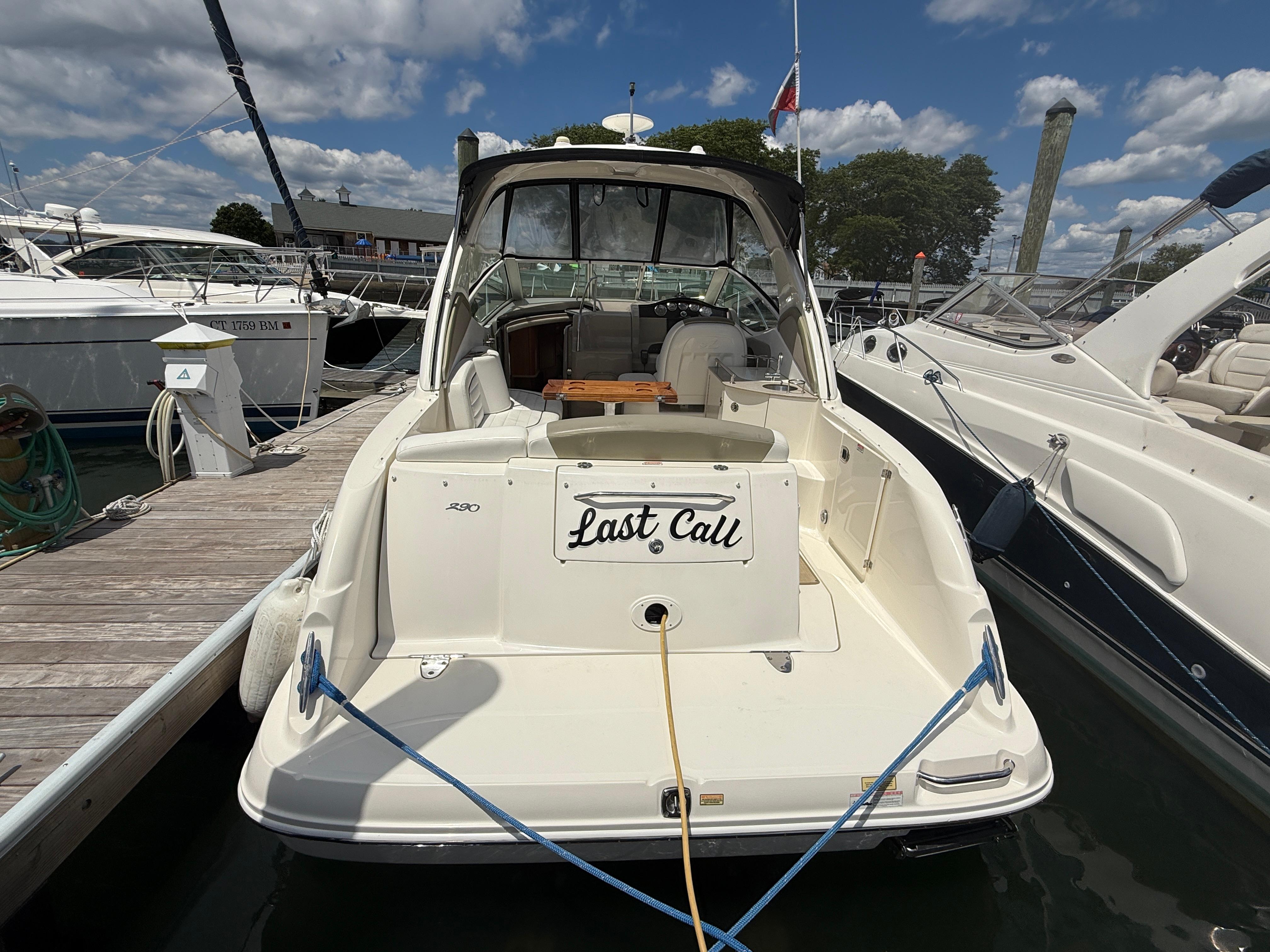2006 Sea Ray 290 Sundancer docked, rear view with "Last Call" nameplate.