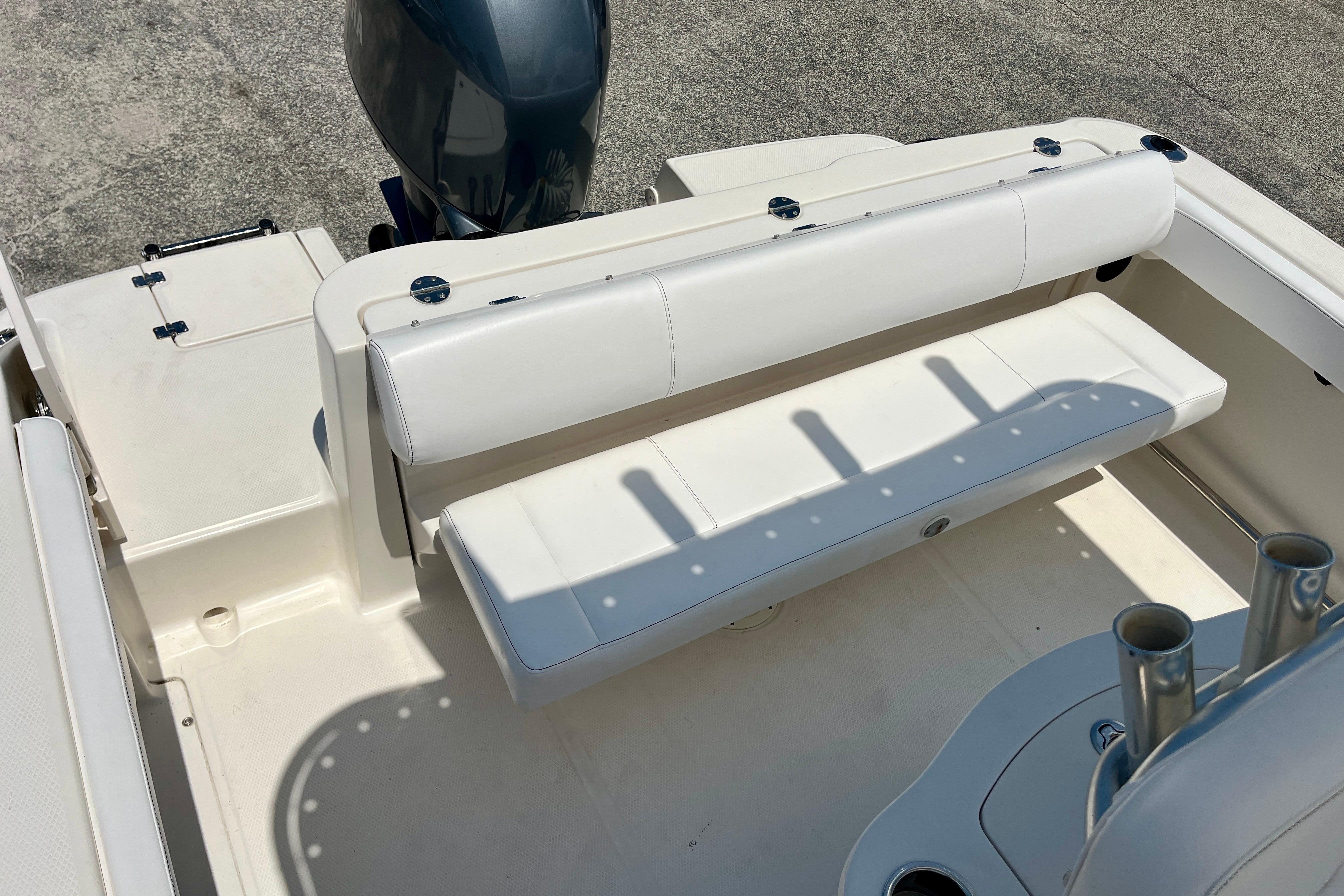 2016 Robalo R222 Center Console boat interior with white seating and rod holders.