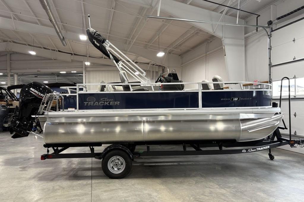 2026 Sun Tracker Bass Buggy 18 DLX pontoon boat in a showroom setting.