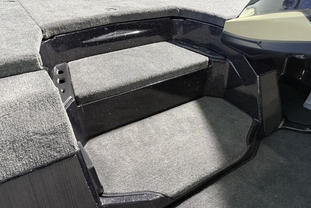 Interior of 2026 Skeeter ZXE21 boat with carpeted steps and seating area.
