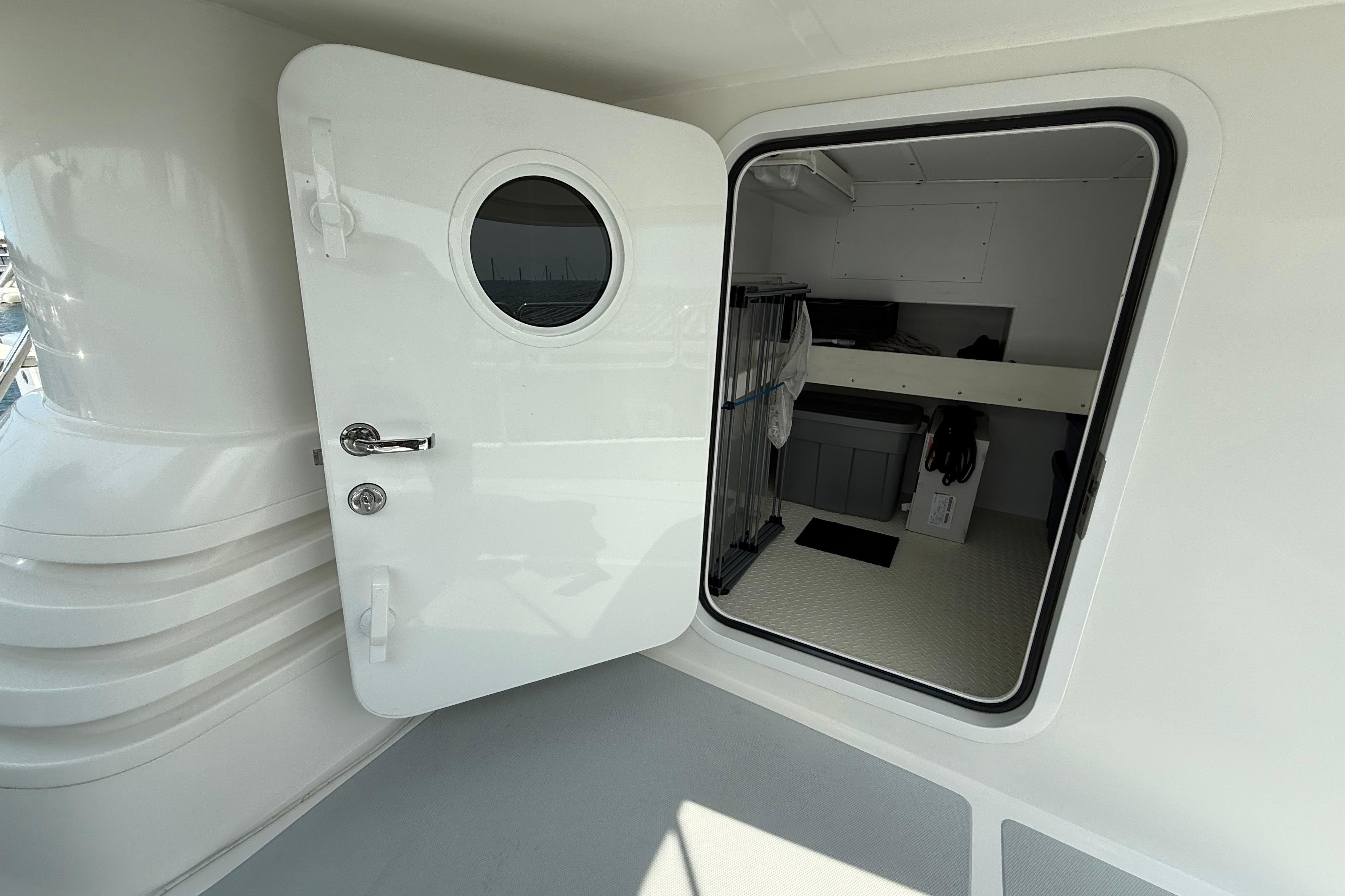 Open door on 2009 Nordhavn N64 yacht, revealing interior storage space.