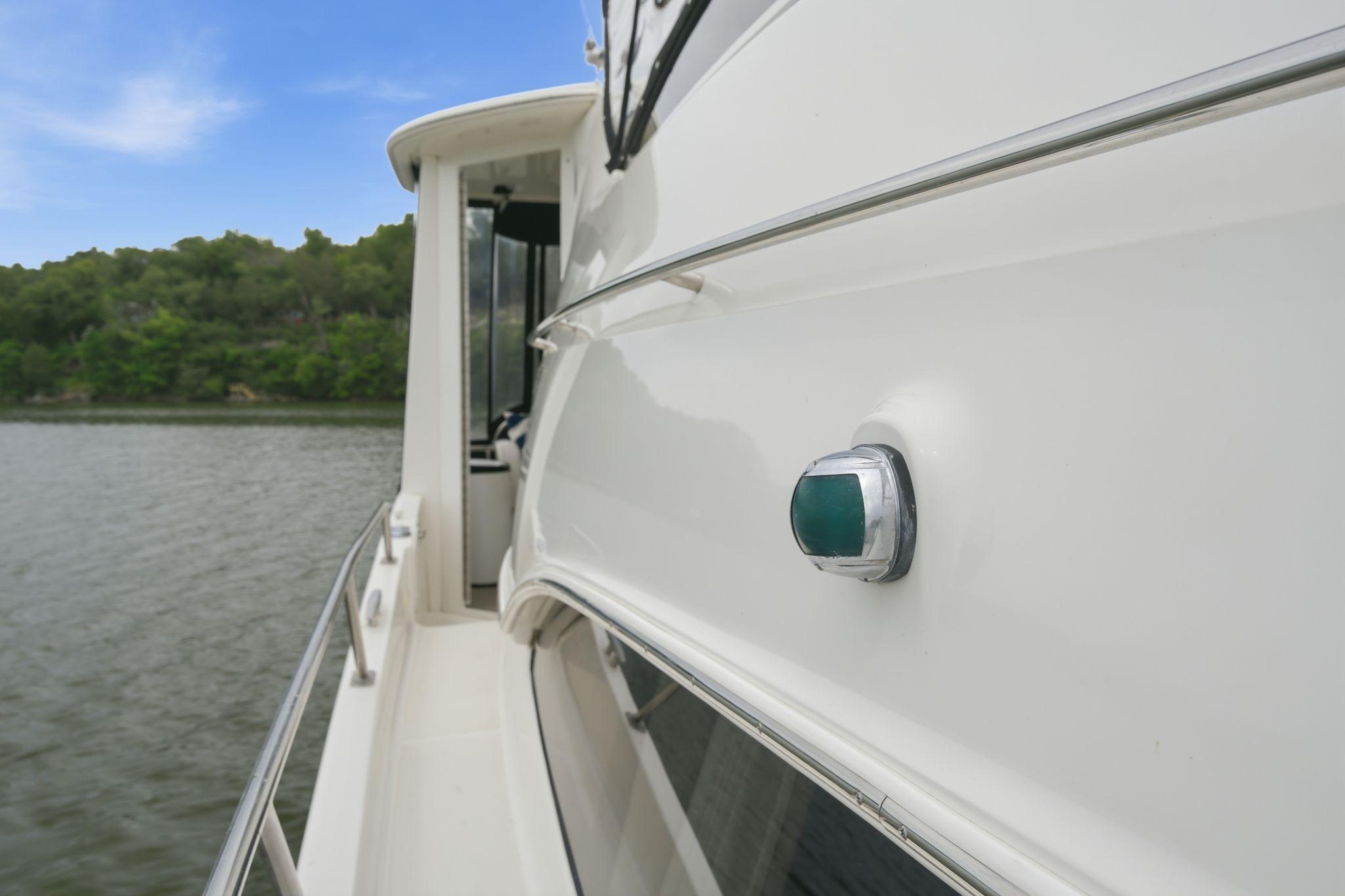 2005 Carver 39 Motor Yacht side view on calm water, showcasing sleek design.
