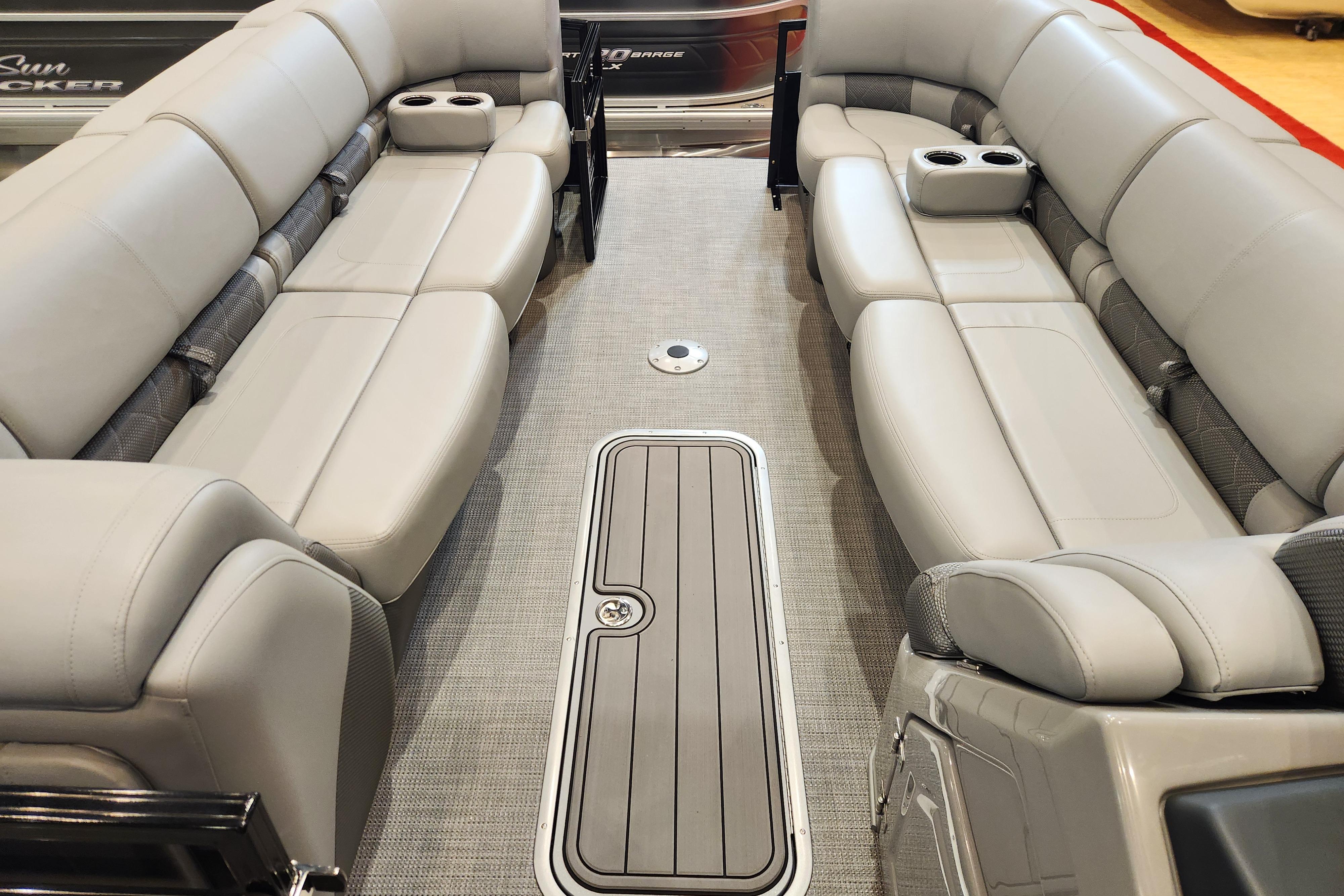 Luxurious interior of 2025 Regency 250 LE3 pontoon boat with plush seating and cup holders.