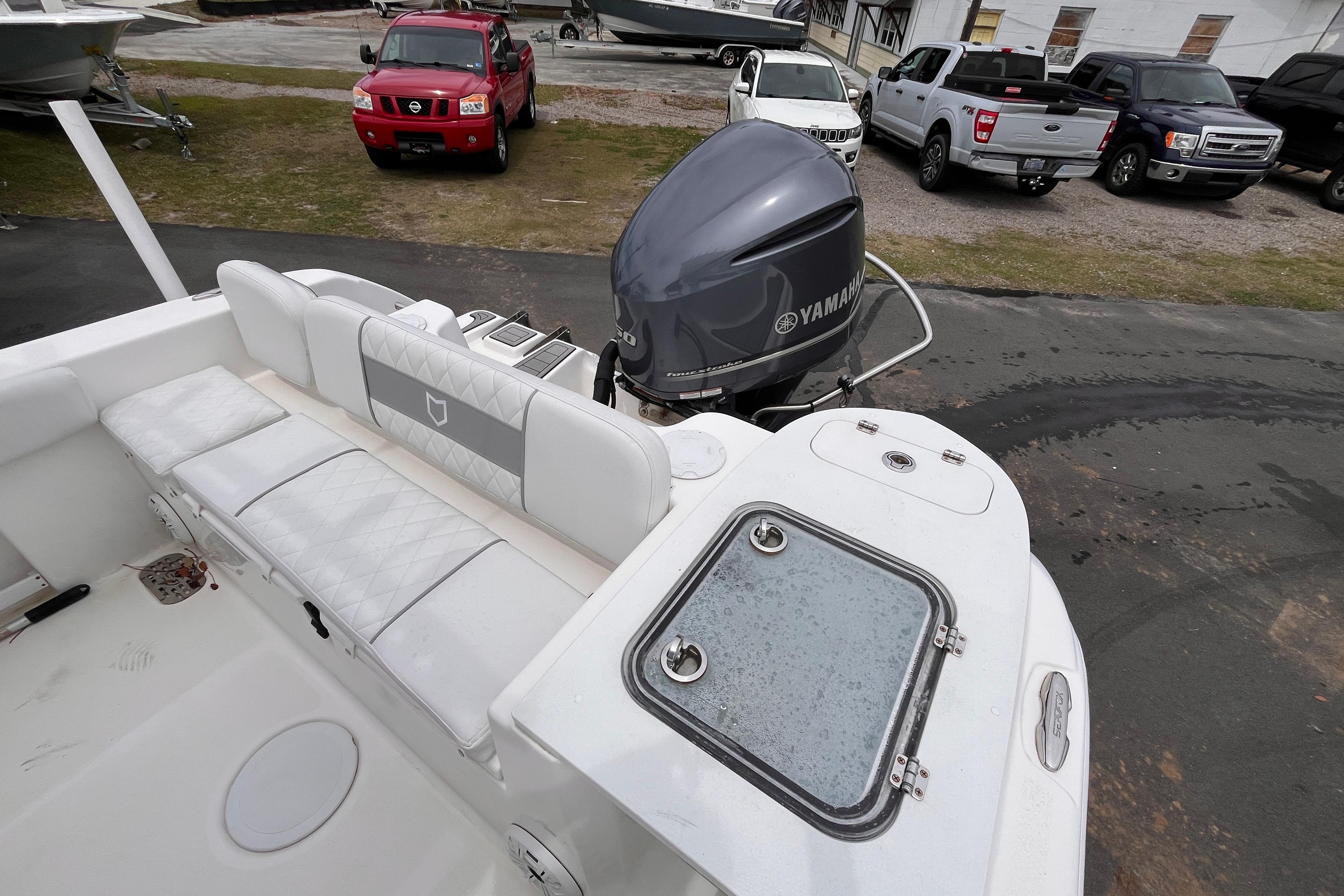 2020 Sea Fox 248 Commander boat with Yamaha outboard motor, parked near trucks.