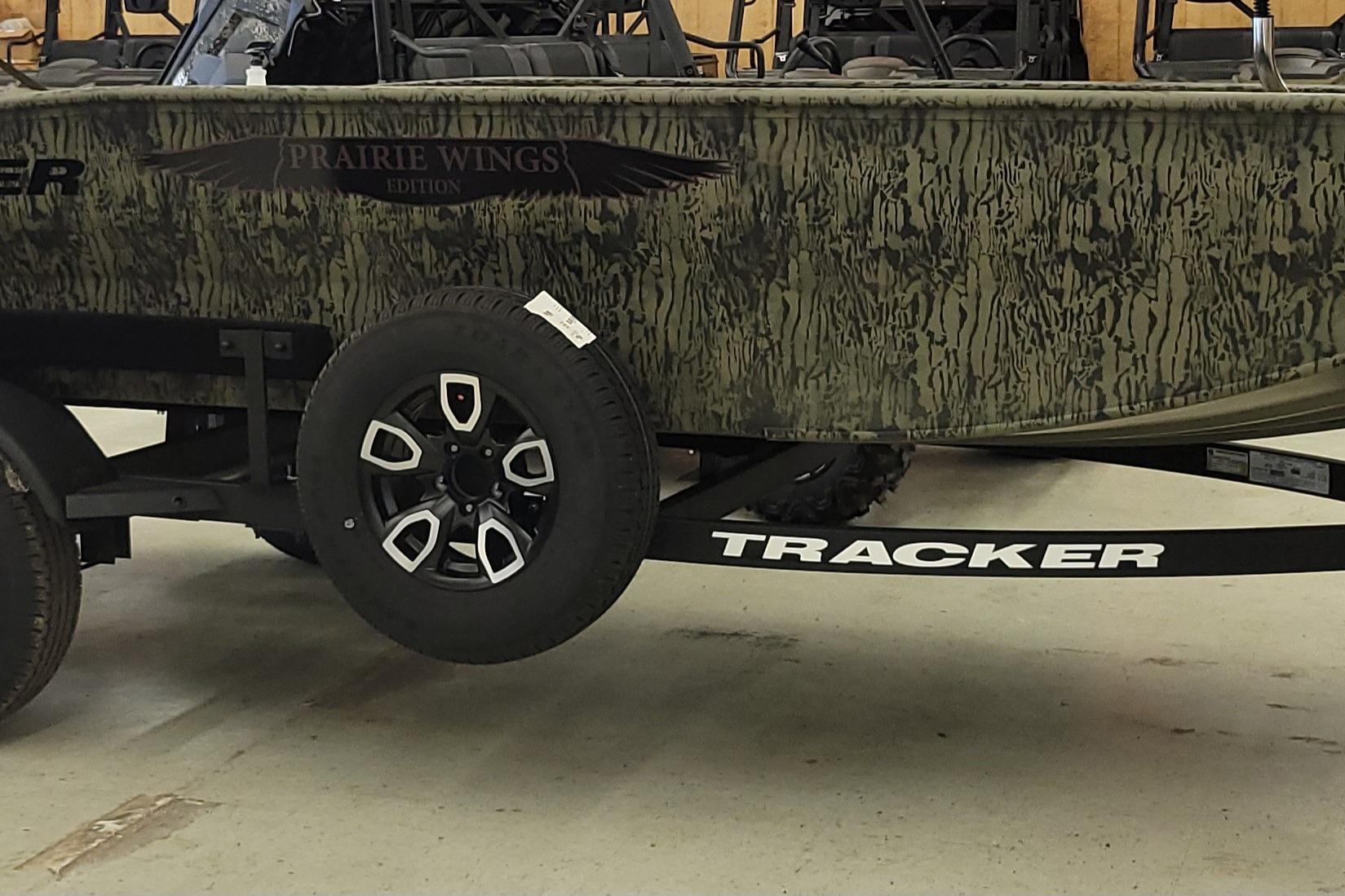 2026 Tracker Grizzly 1650 T Prairie Wings Edition boat with camouflage design on trailer.
