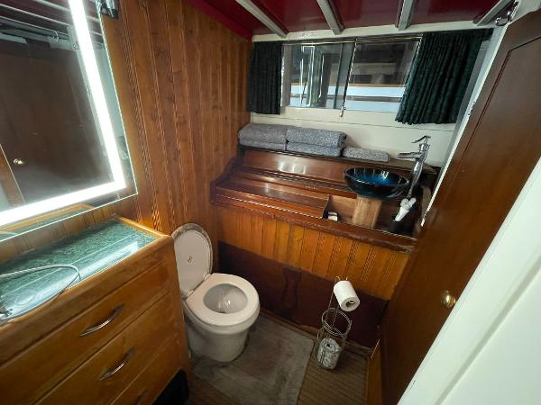 1951 Chris-Craft Catalina boat bathroom with wooden interior and modern fixtures.