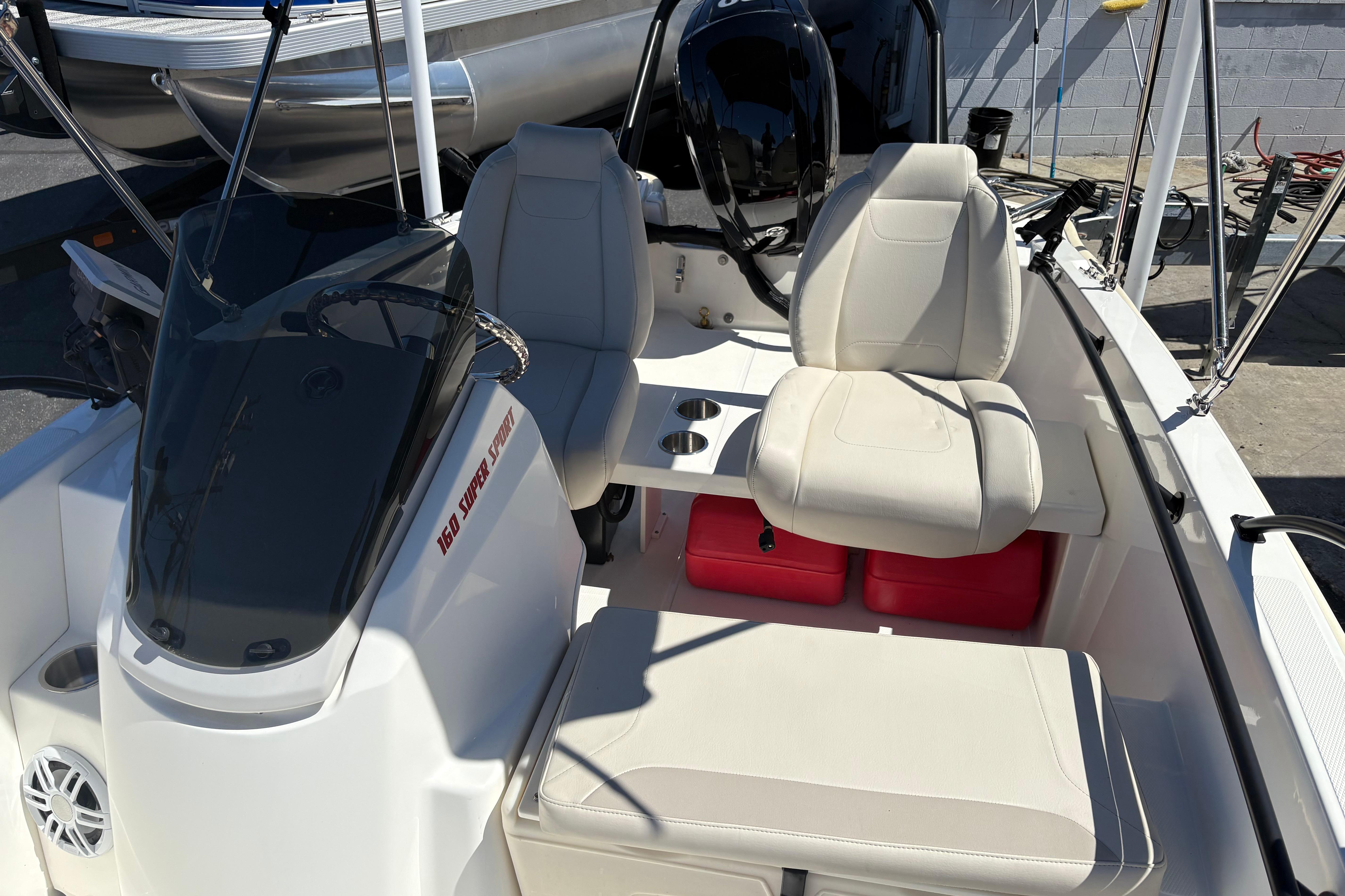 2024 Boston Whaler 160 Super Sport boat interior with seating and steering console.