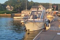 Boat docked at marina, Mission-Craft Mis 35, 2010 model, in serene waters.
