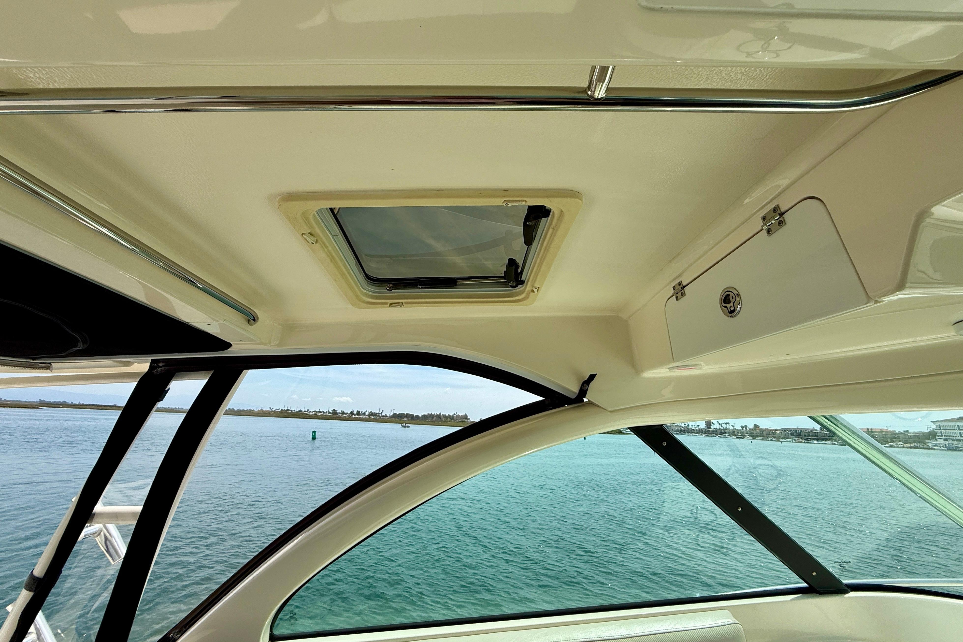 Interior view of 2012 Pursuit OS 345 Offshore boat with ocean backdrop.