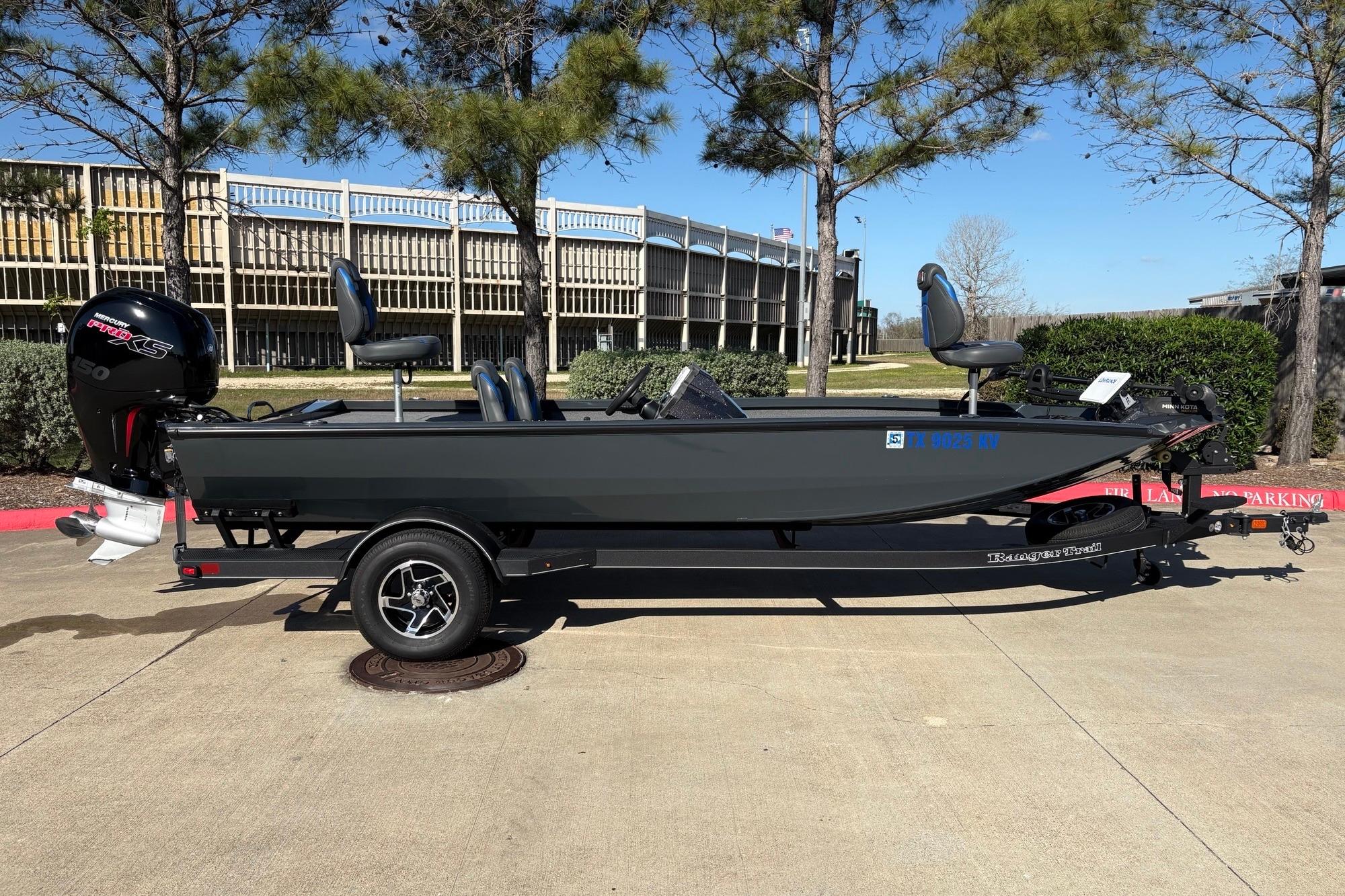 2024 Ranger RT198P fishing boat on trailer, parked outdoors.