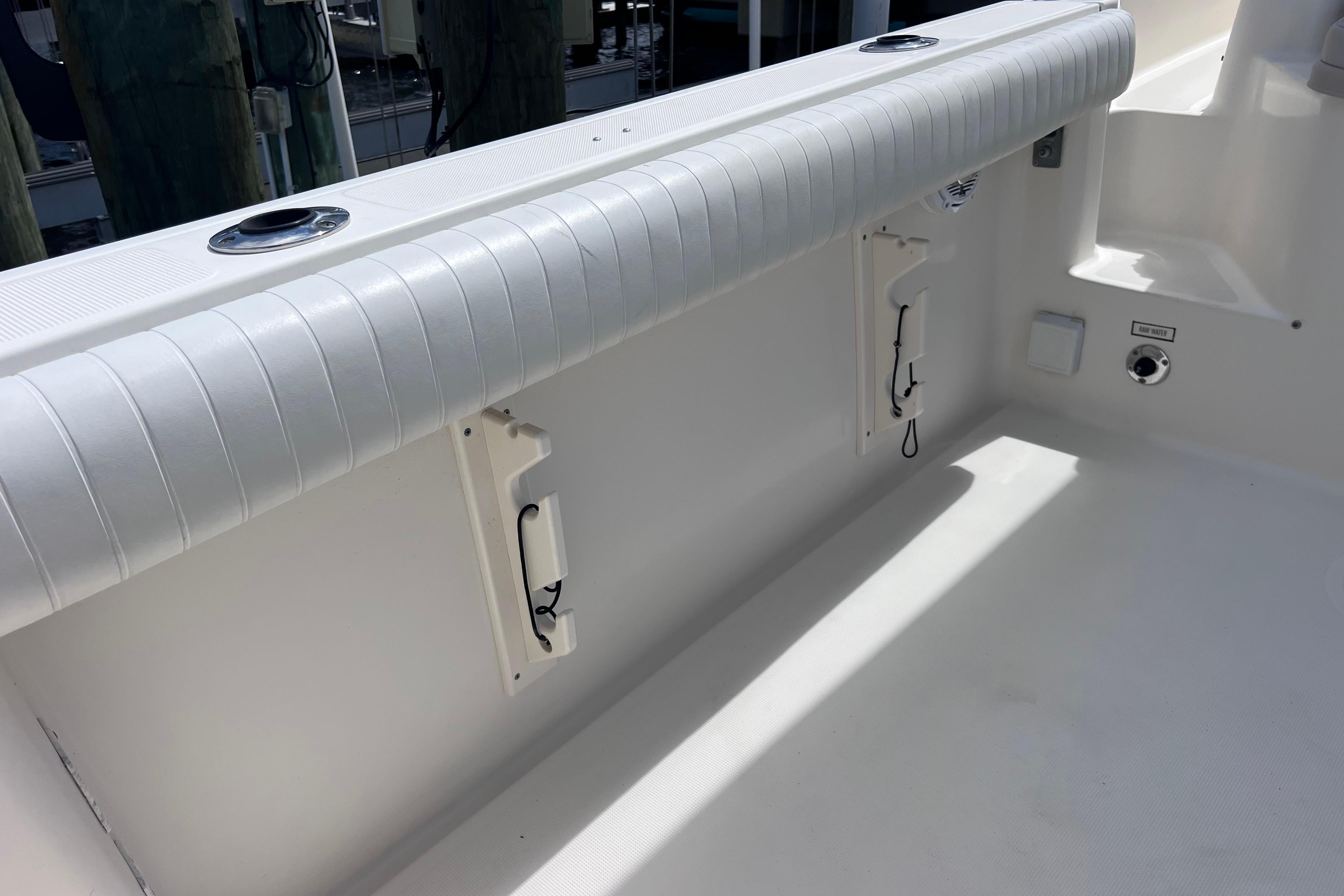 2004 Pursuit 2870 Walkaround boat interior with rod holders and cushioned seating.