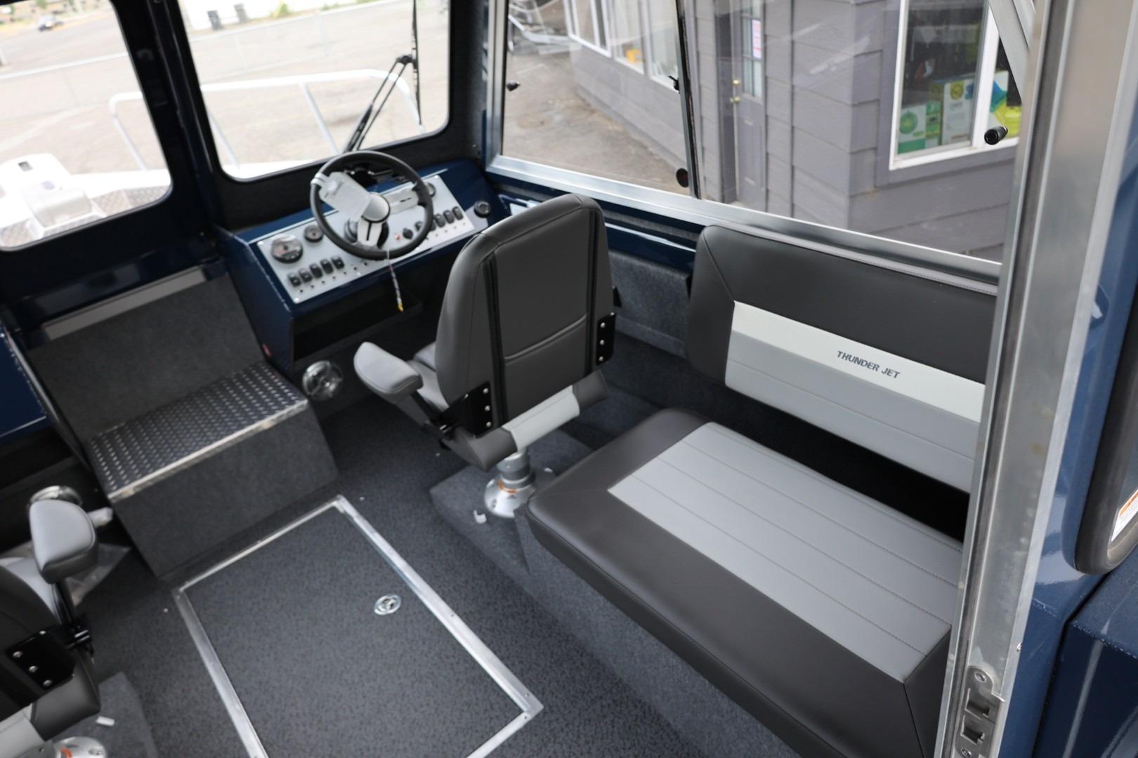 Interior of 2026 Thunder Jet 24 Alexis Pro boat, featuring steering wheel and seating.