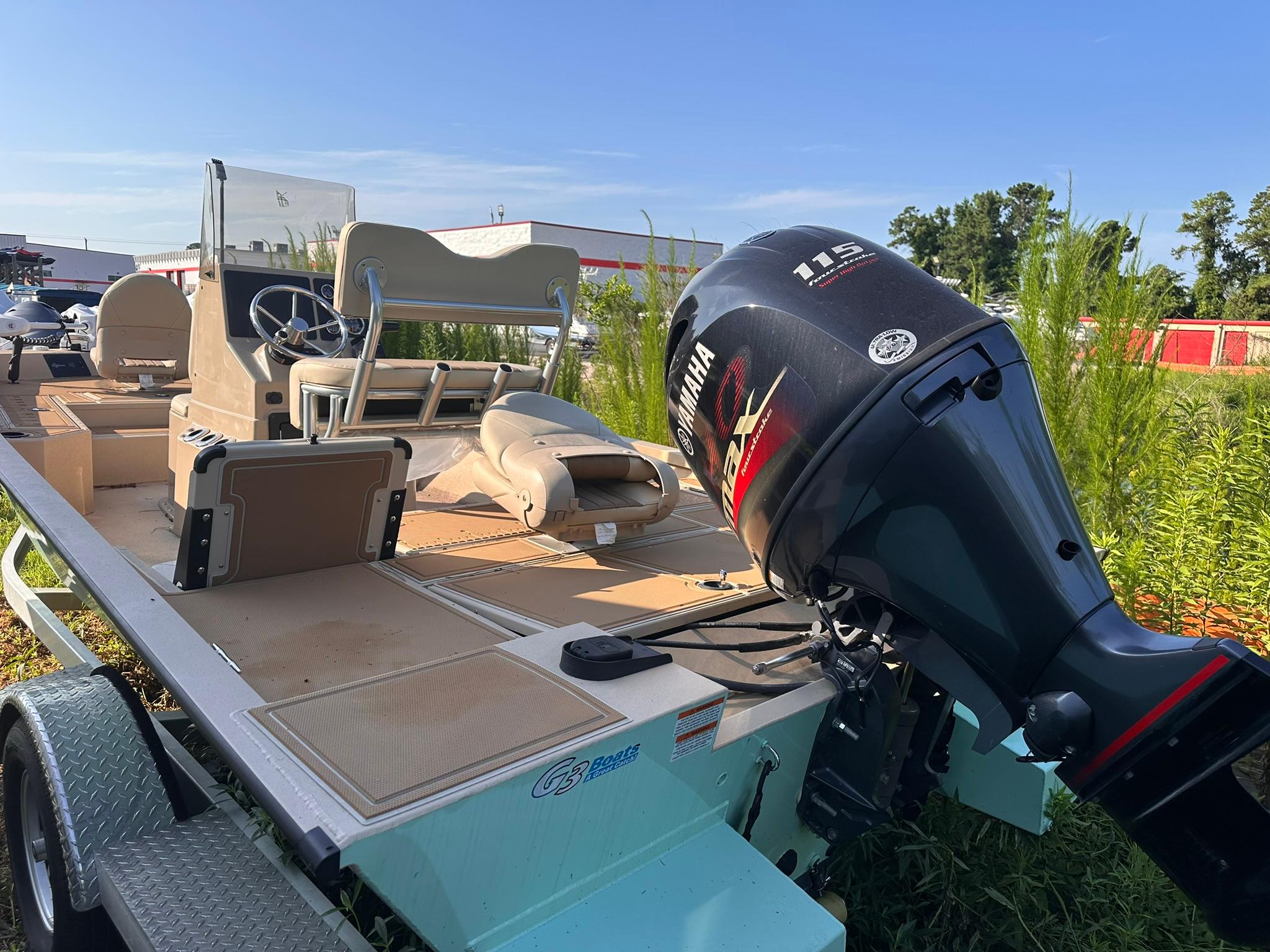 2024 G3 Bay 20 GX boat with Yamaha 115 engine, parked outdoors.