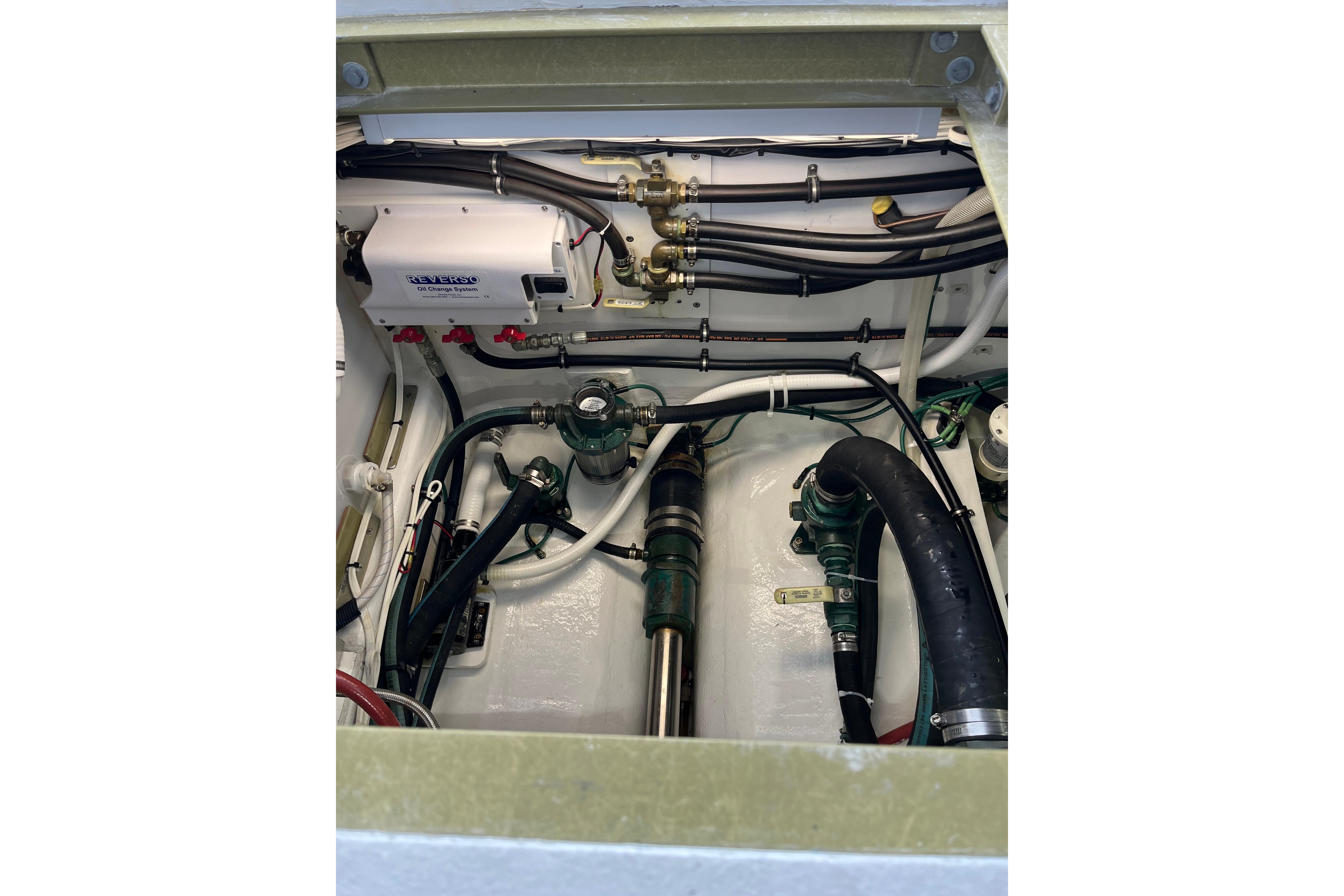 Engine compartment of 2018 H&H Marine Osmond Beal boat, showcasing mechanical components and wiring.