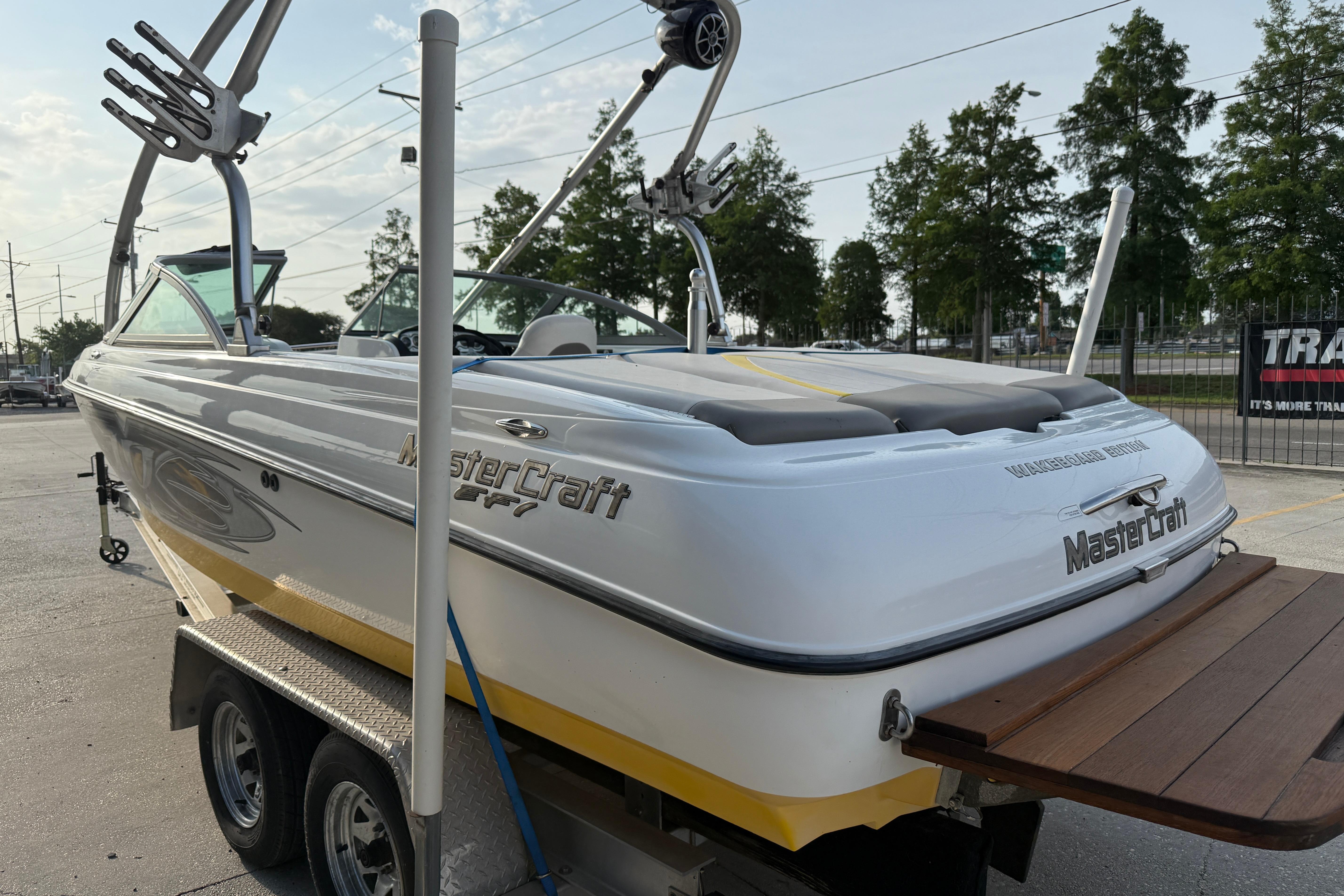 2005 MasterCraft X10 boat on trailer, featuring sleek design and wakeboard tower.