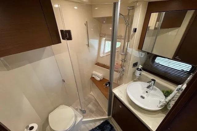 Luxurious bathroom in 2016 Sea Ray Sundancer 510 yacht with modern fixtures and glass shower.