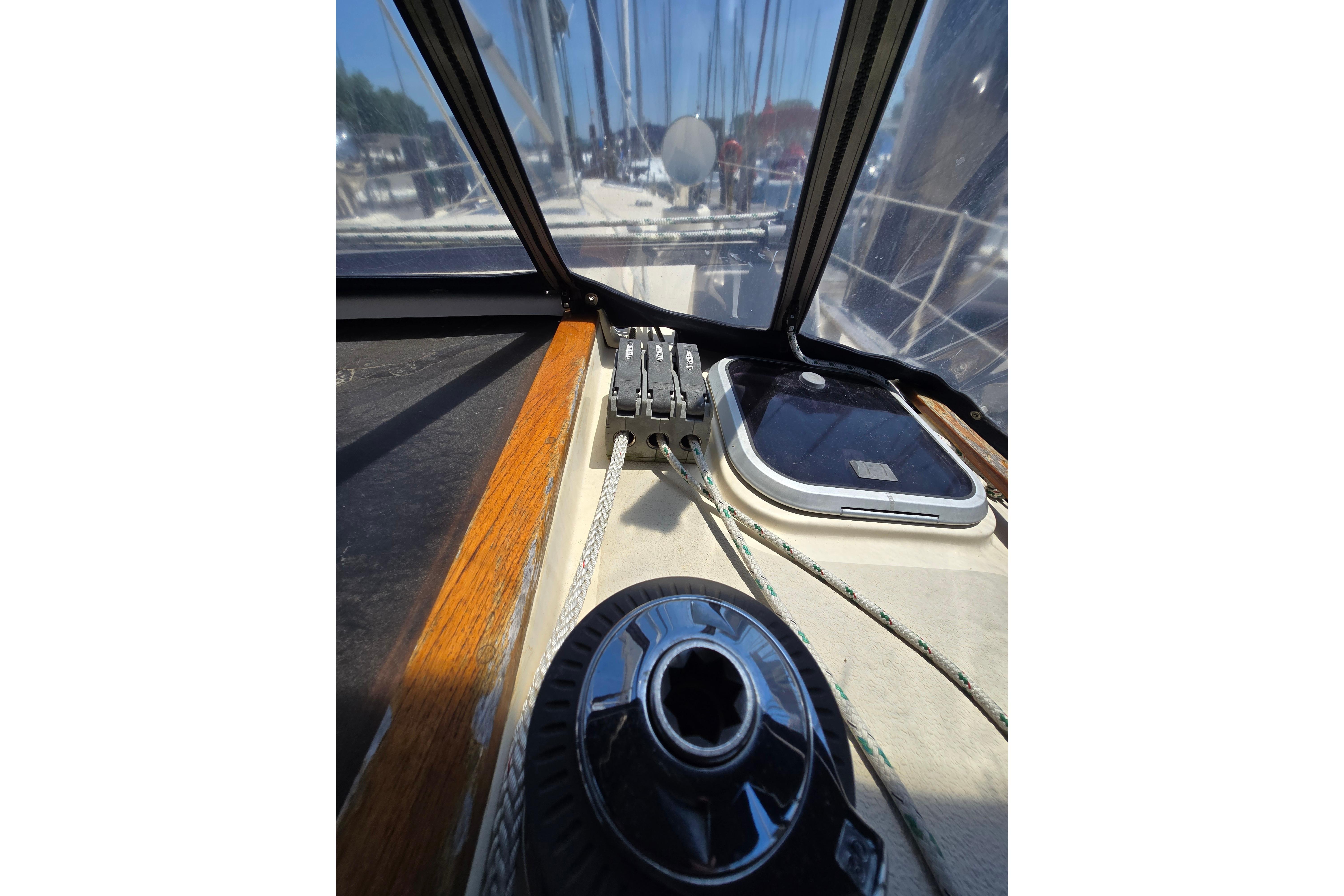 Interior view of a 1993 Caliber 35 sailboat cockpit with winch and ropes.