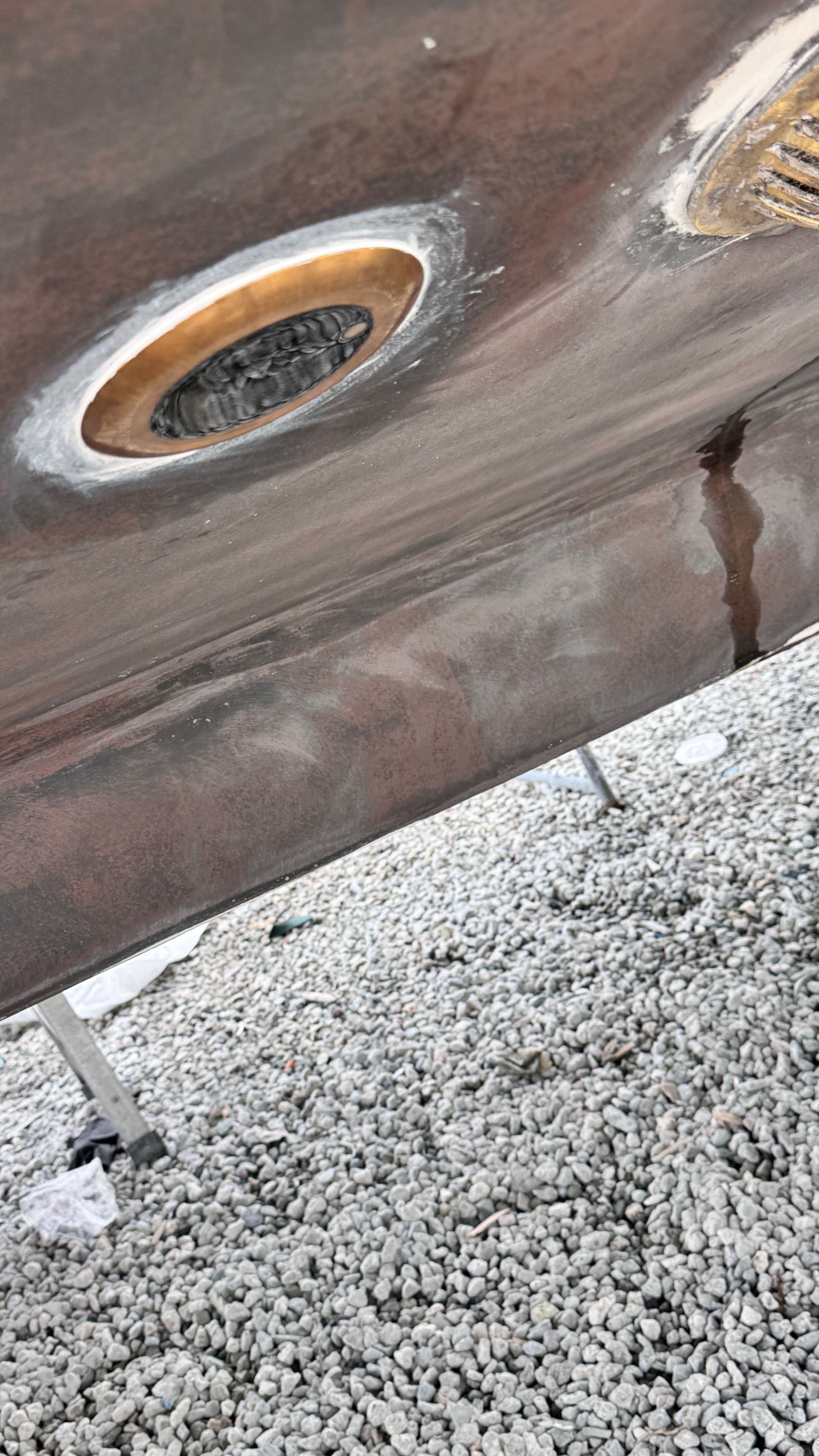 Close-up of the hull of a Tiara Yachts 4300 Open on gravel.