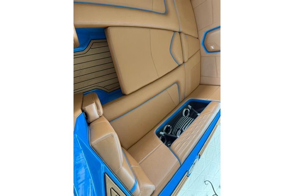2020 Nautique Super Air Nautique G25 interior with tan and blue upholstery.