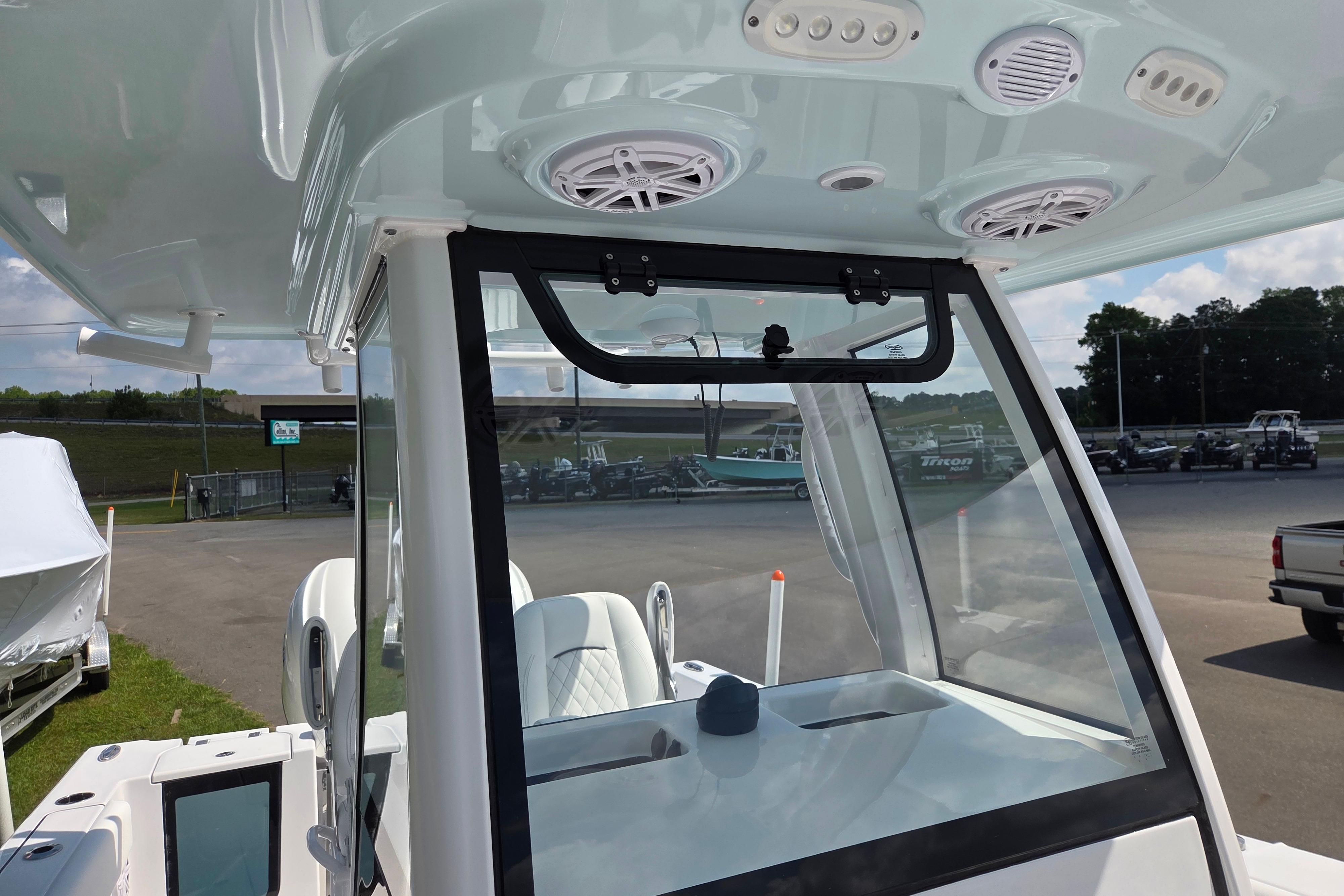 2026 Sportsman Open 252 Center Console boat interior with speakers and windshield.
