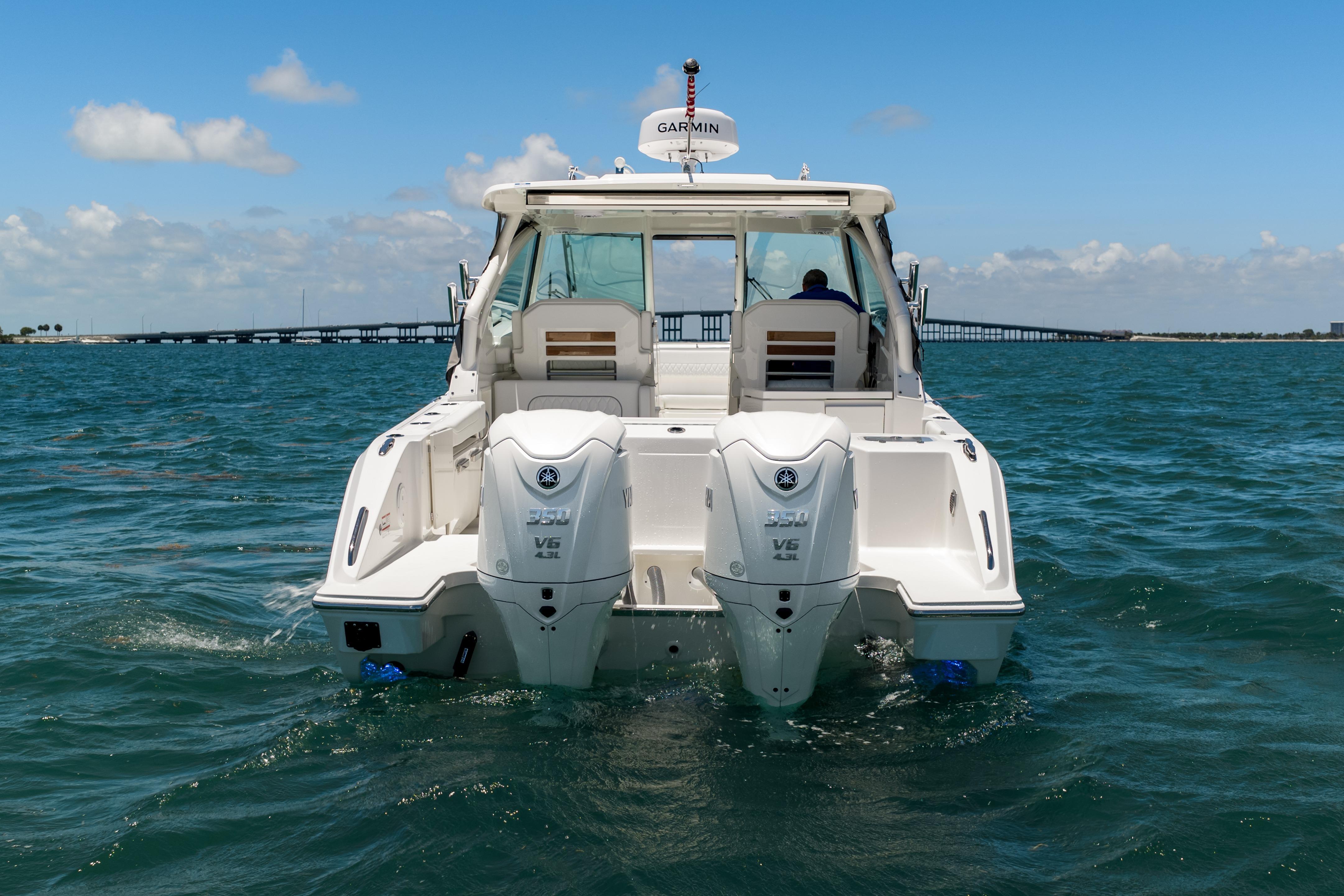 2026 Pursuit DC 326 Dual Console boat cruising on open water.