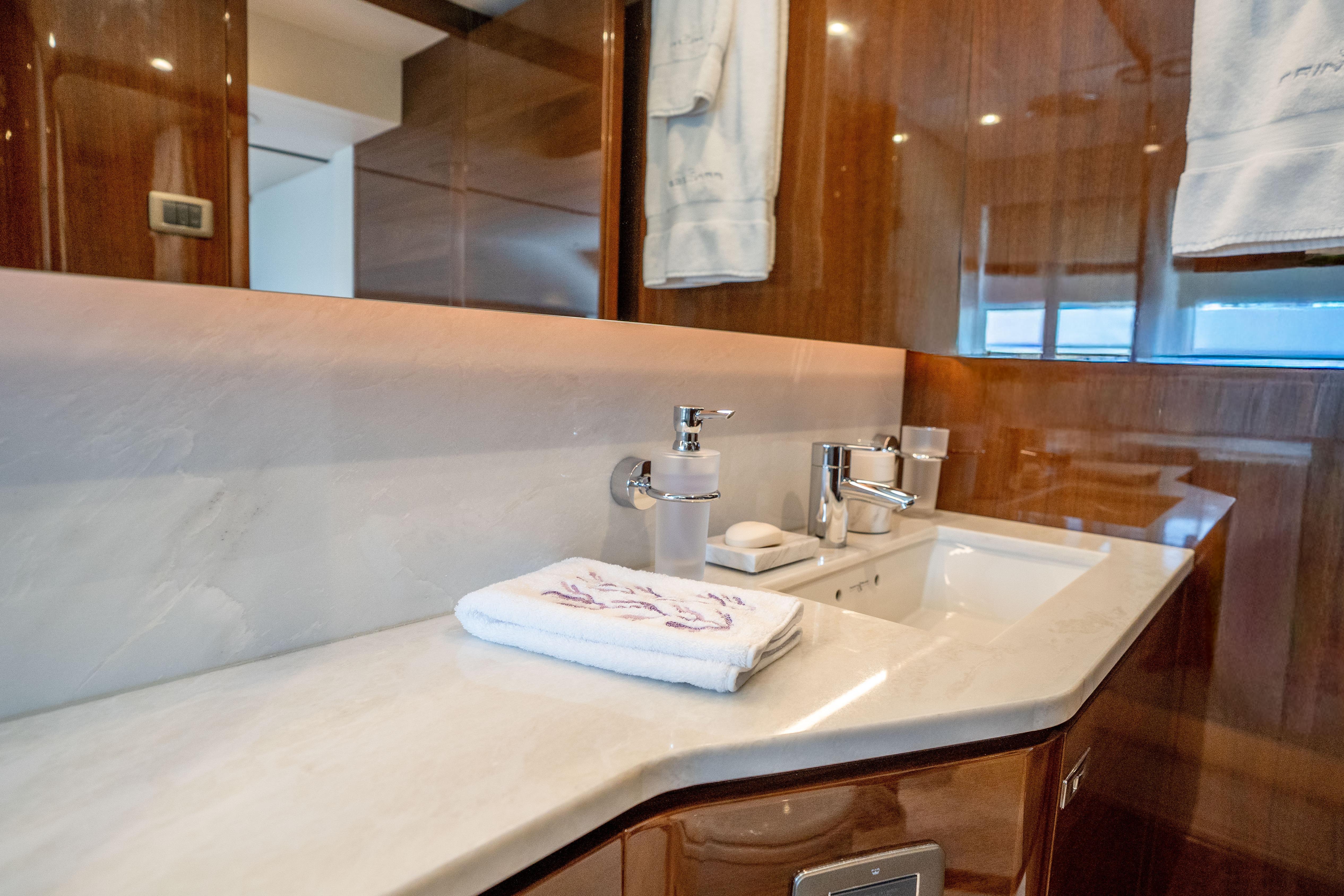 Luxurious bathroom on 2020 Princess Y85 yacht with elegant marble countertop.