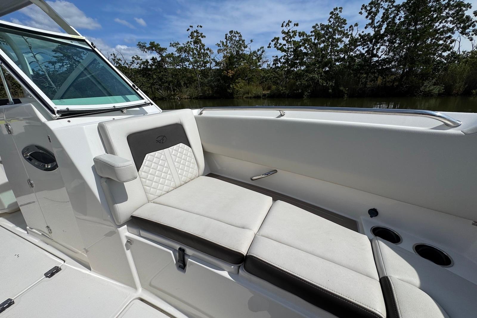 2022 Sailfish 276 DC boat interior with cushioned seating and cup holders.