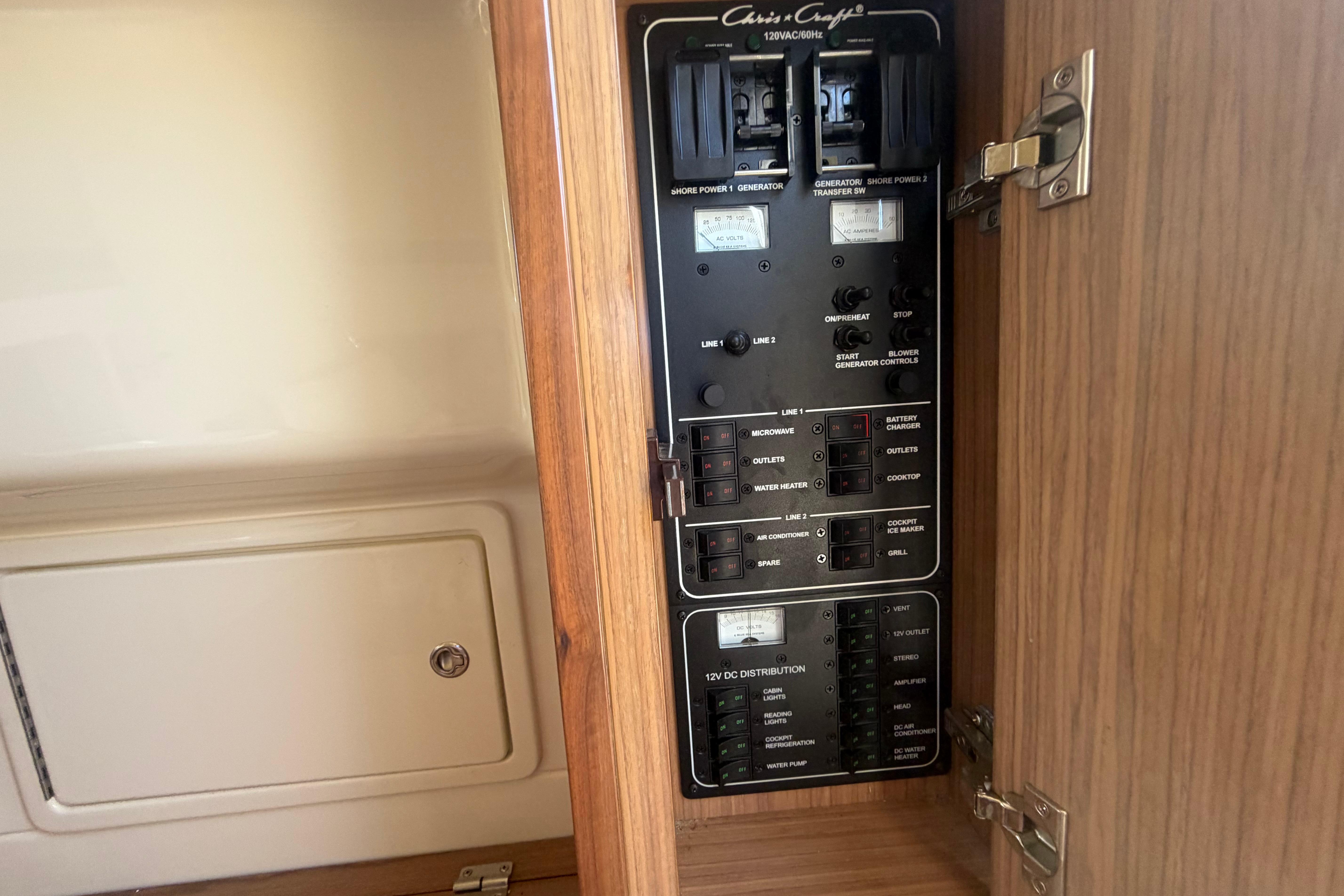 Electrical panel inside 2017 Chris-Craft Catalina 34 boat, showcasing circuit controls.