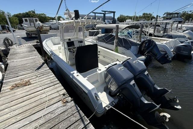 2006 Sailfish 2660 CC boat docked with twin outboard engines.