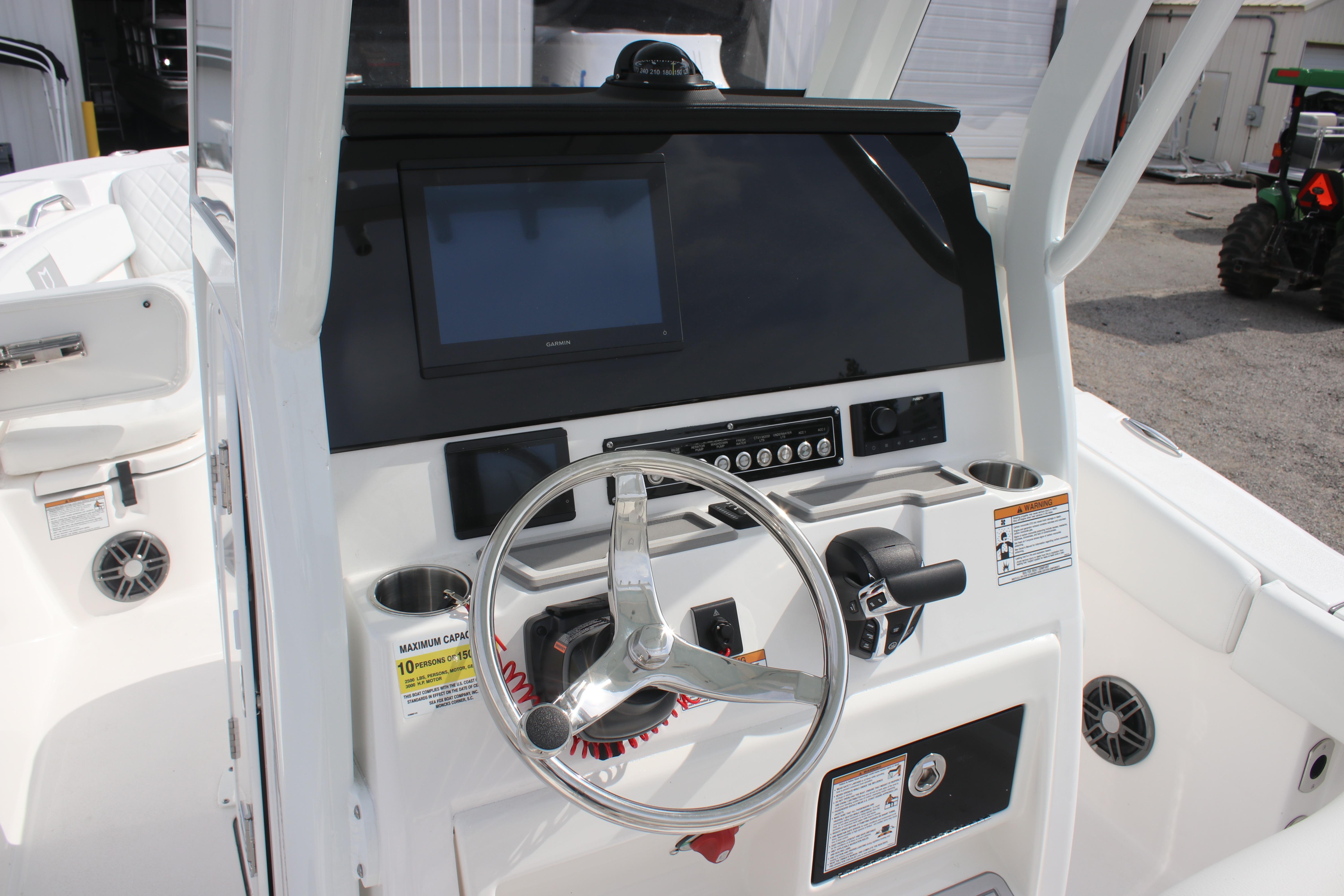 2026 Sea Fox 248 Commander boat dashboard with steering wheel and control panel.