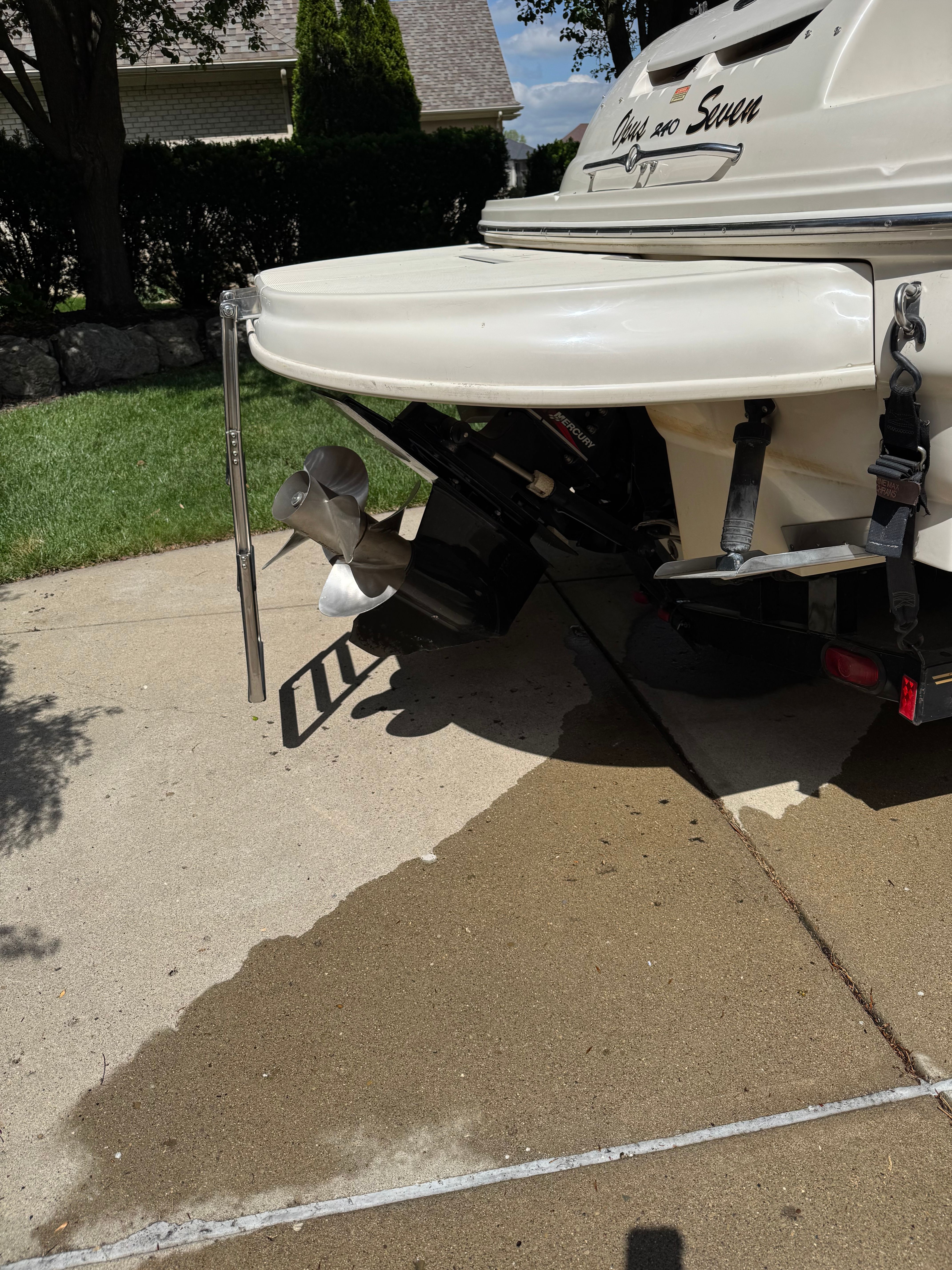 Rear view of a 2001 Sea Ray 240 Sundeck boat on a driveway.