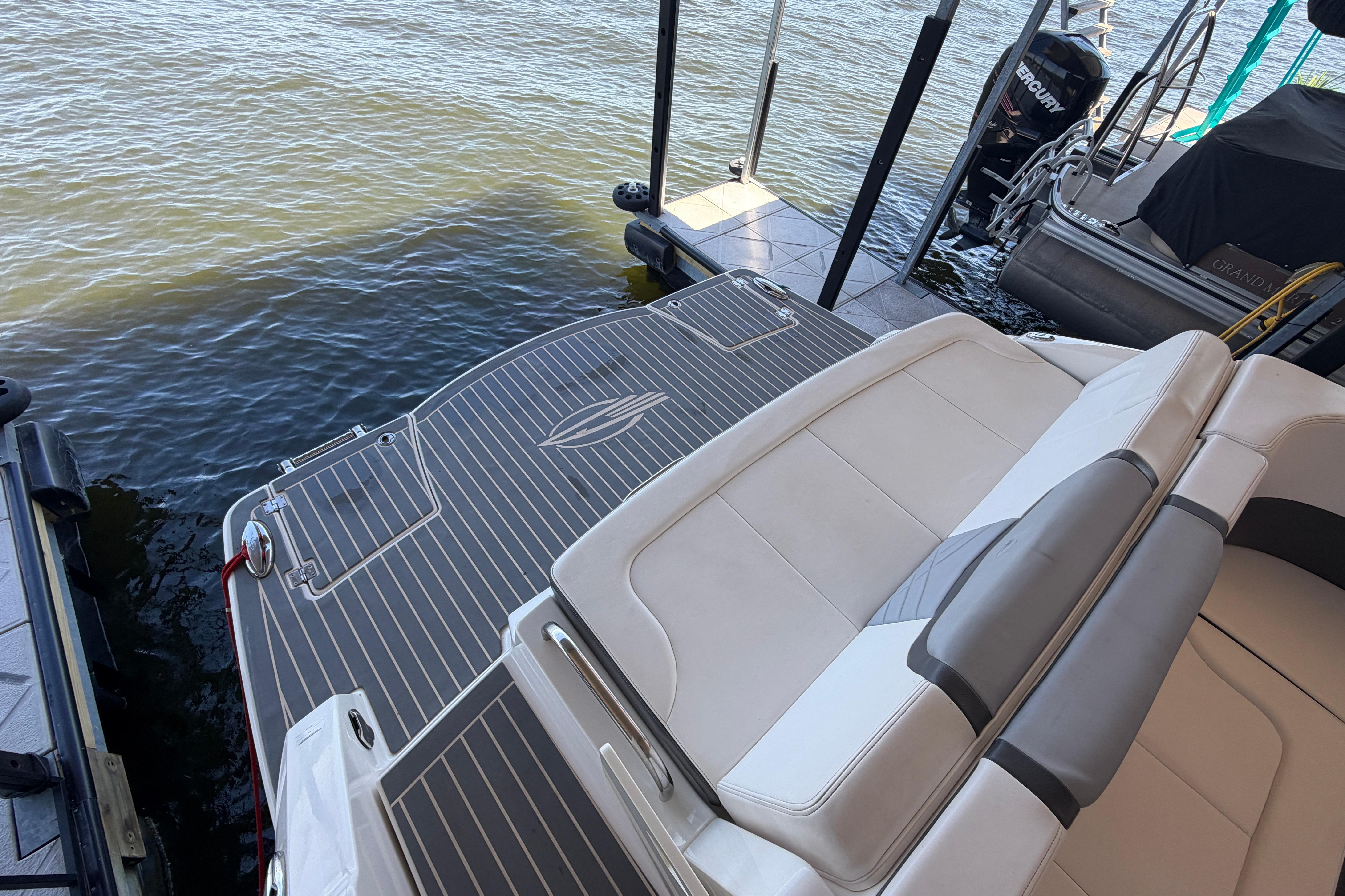2018 Chaparral 347 SSX boat with sleek deck design docked by the water.
