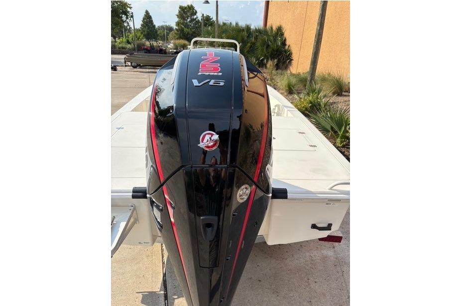 2026 Mako 18 Pro Skiff with powerful V6 engine, parked outdoors.